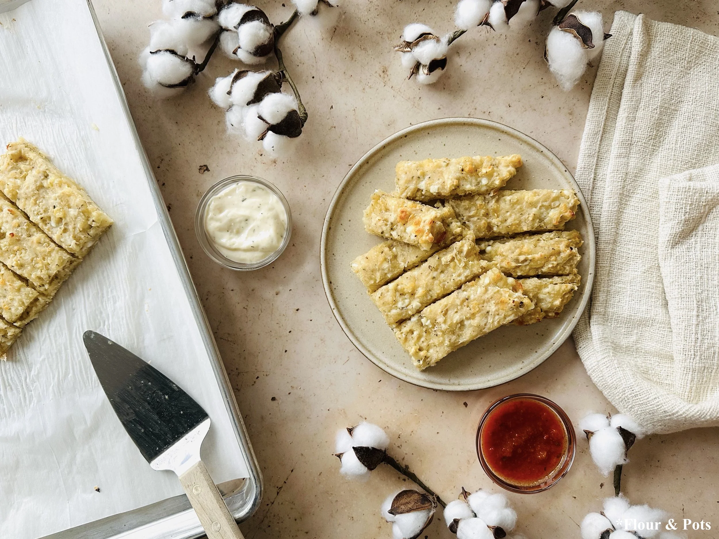 Freshly baked cheesy breadsticks cut into pull-apart pieces.