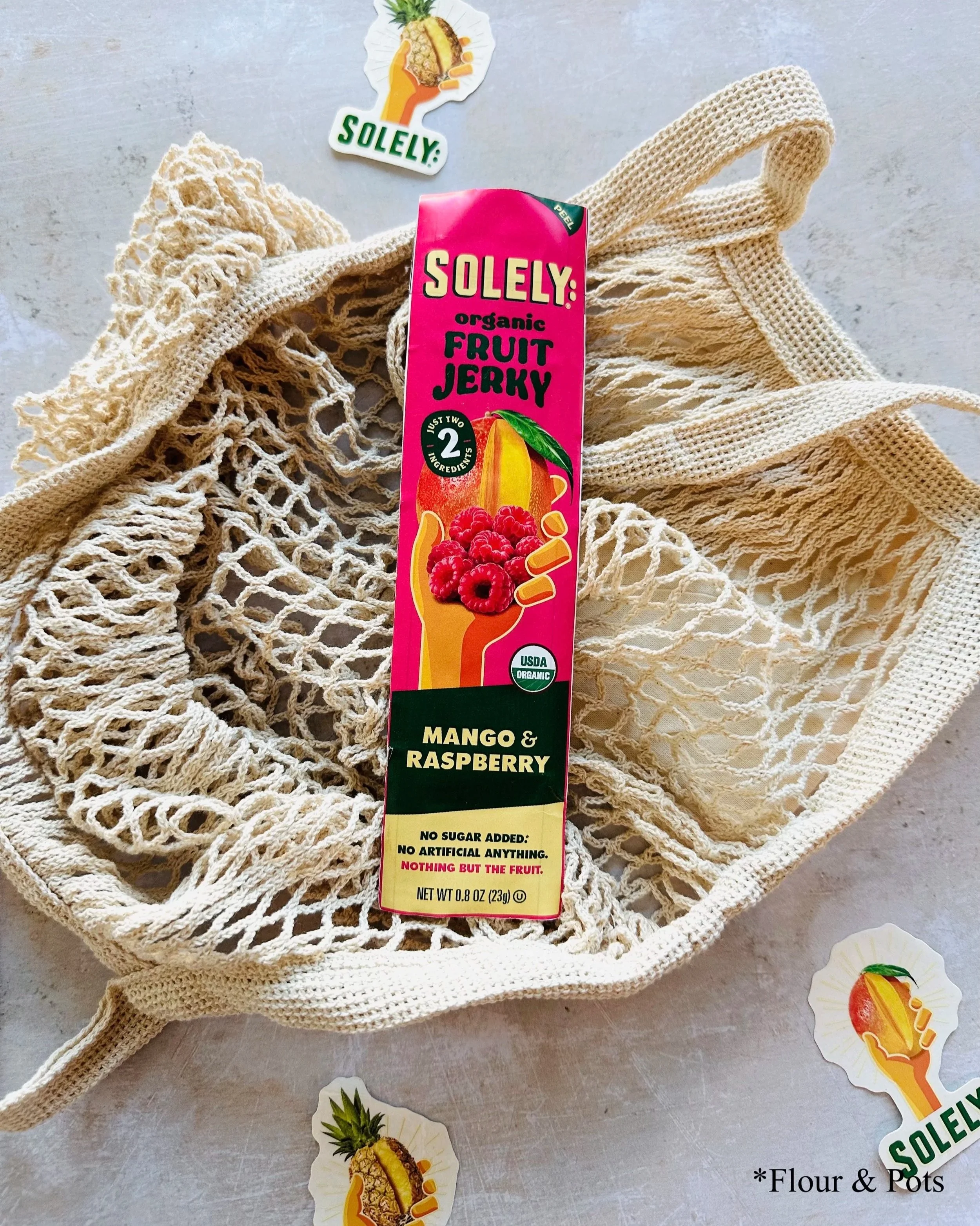 Solely Organic Mango & Raspberry fruit jerky stick package featuring a refreshing, fruity design.