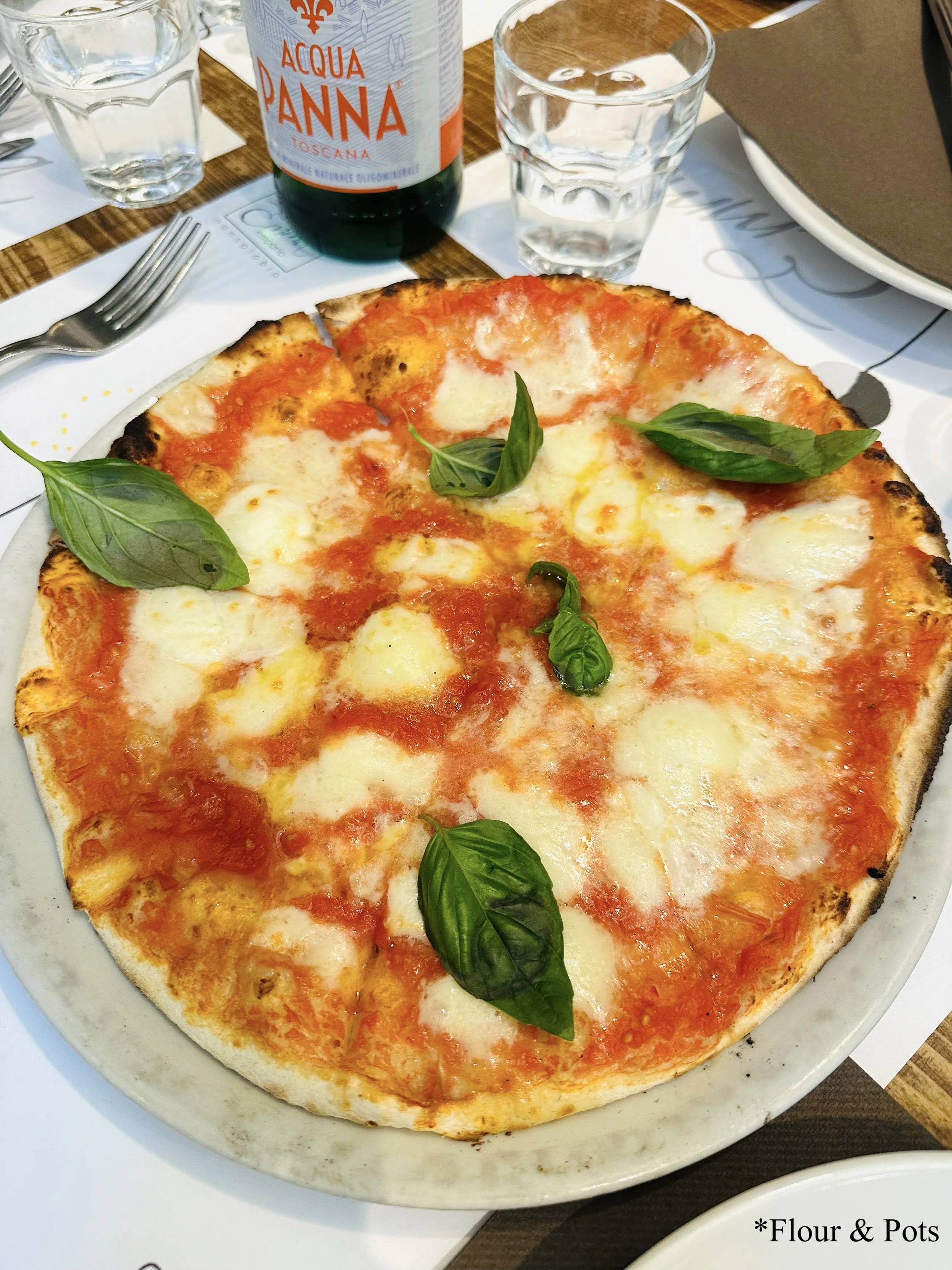 argherita pizza from Emma in Rome, Italy — topped with Pomilia tomato sauce, fresh mozzarella, and fragrant basil leaves.