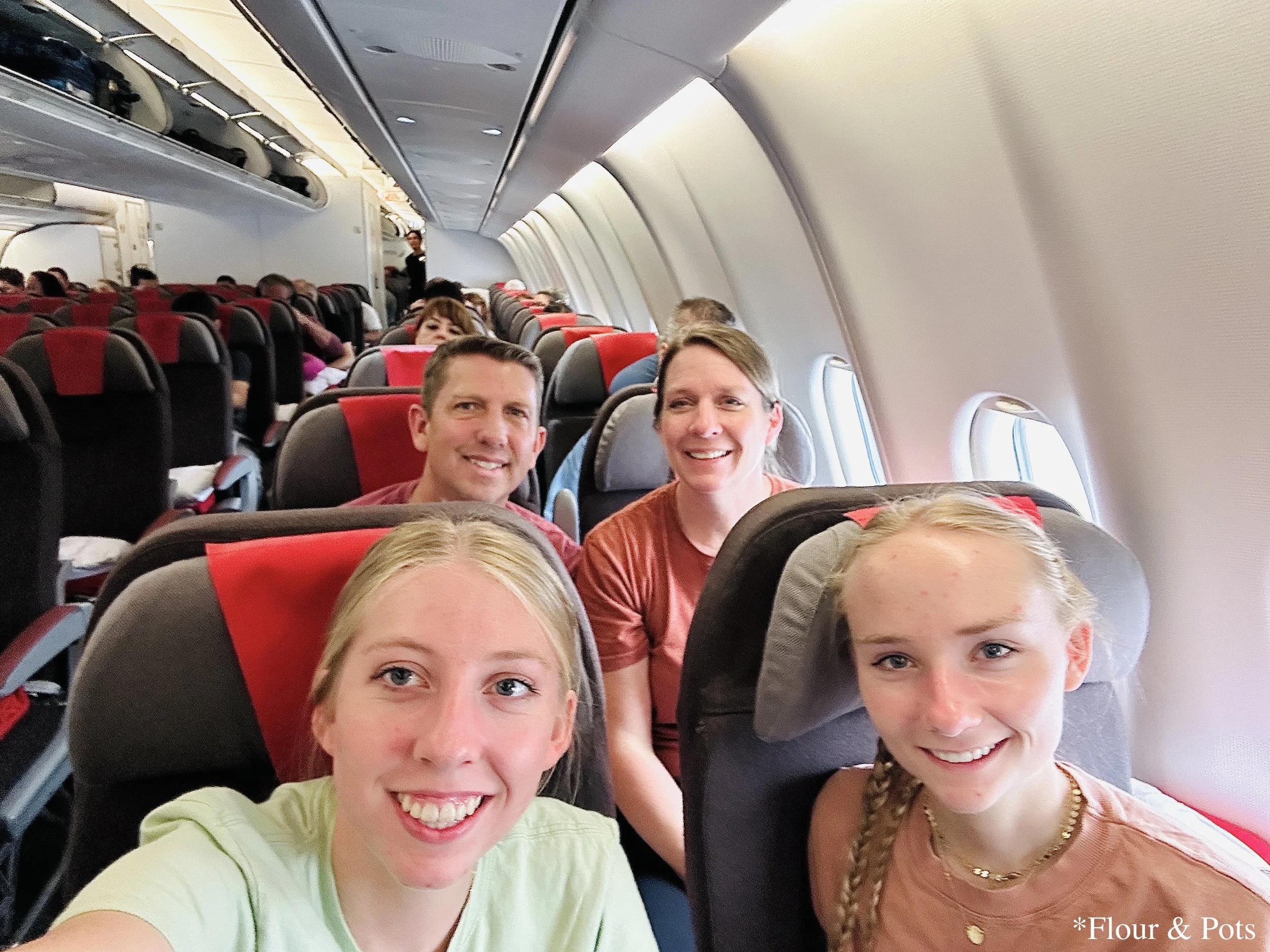A family selfie taken in our seats on an Iberia flight before takeoff from Madrid (MAD) to Dallas/Fort Worth (DFW).