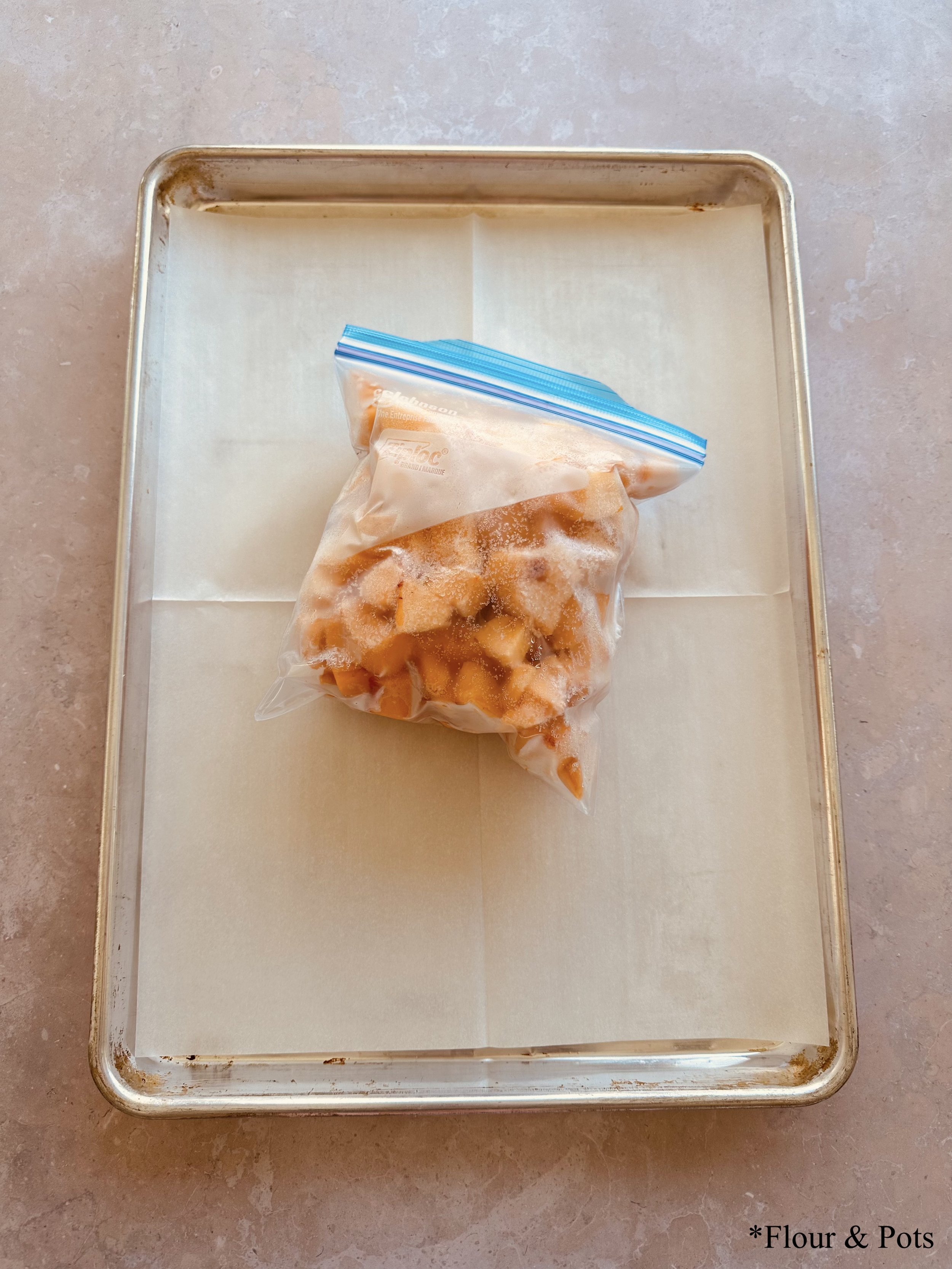 Step 8: Frozen peach slices stored in a labeled zip-lock bag, ready for long-term freezer storage.