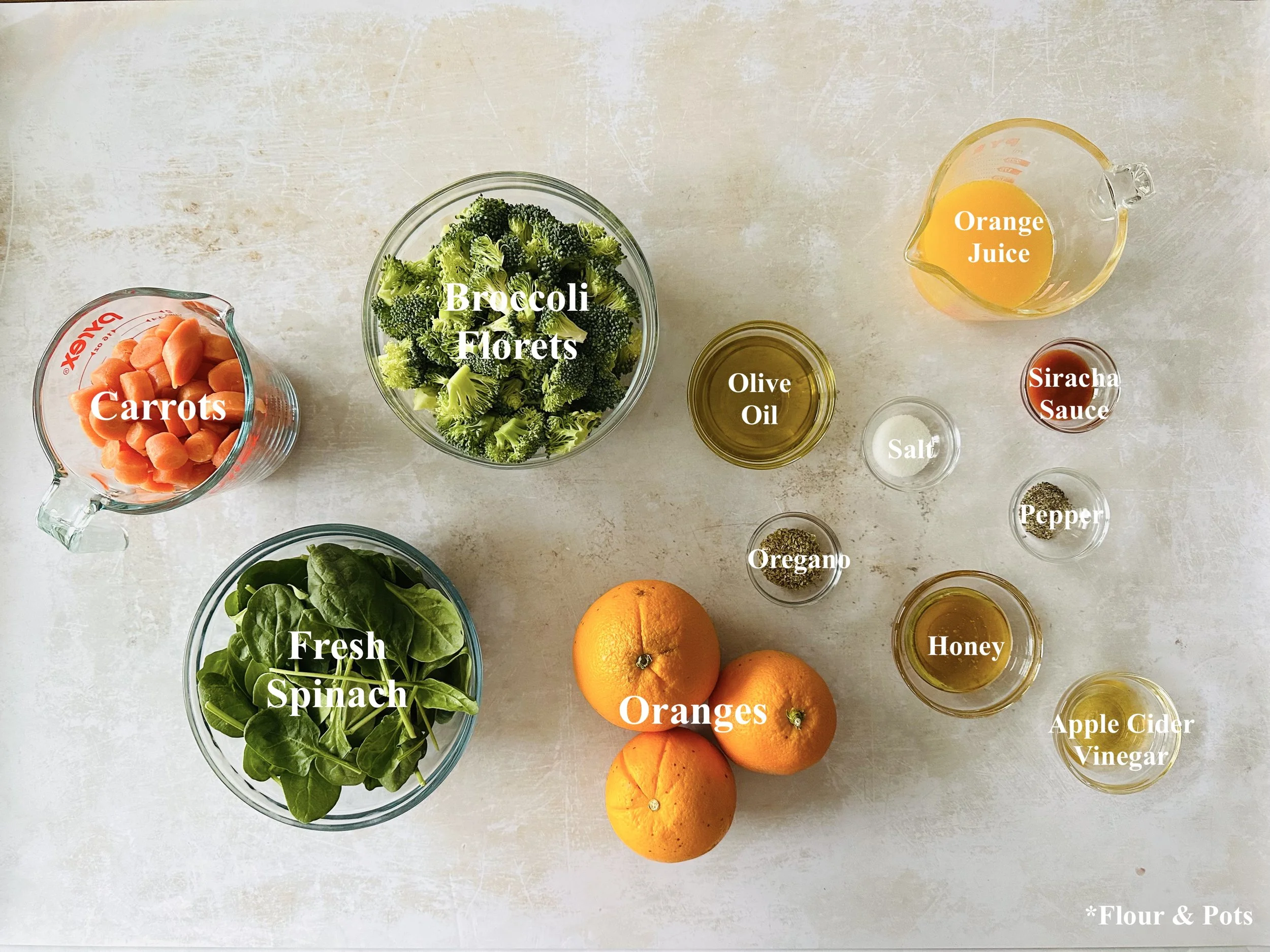 Fresh spinach orange salad topped with roasted vegetables and chopped cashews ingredients