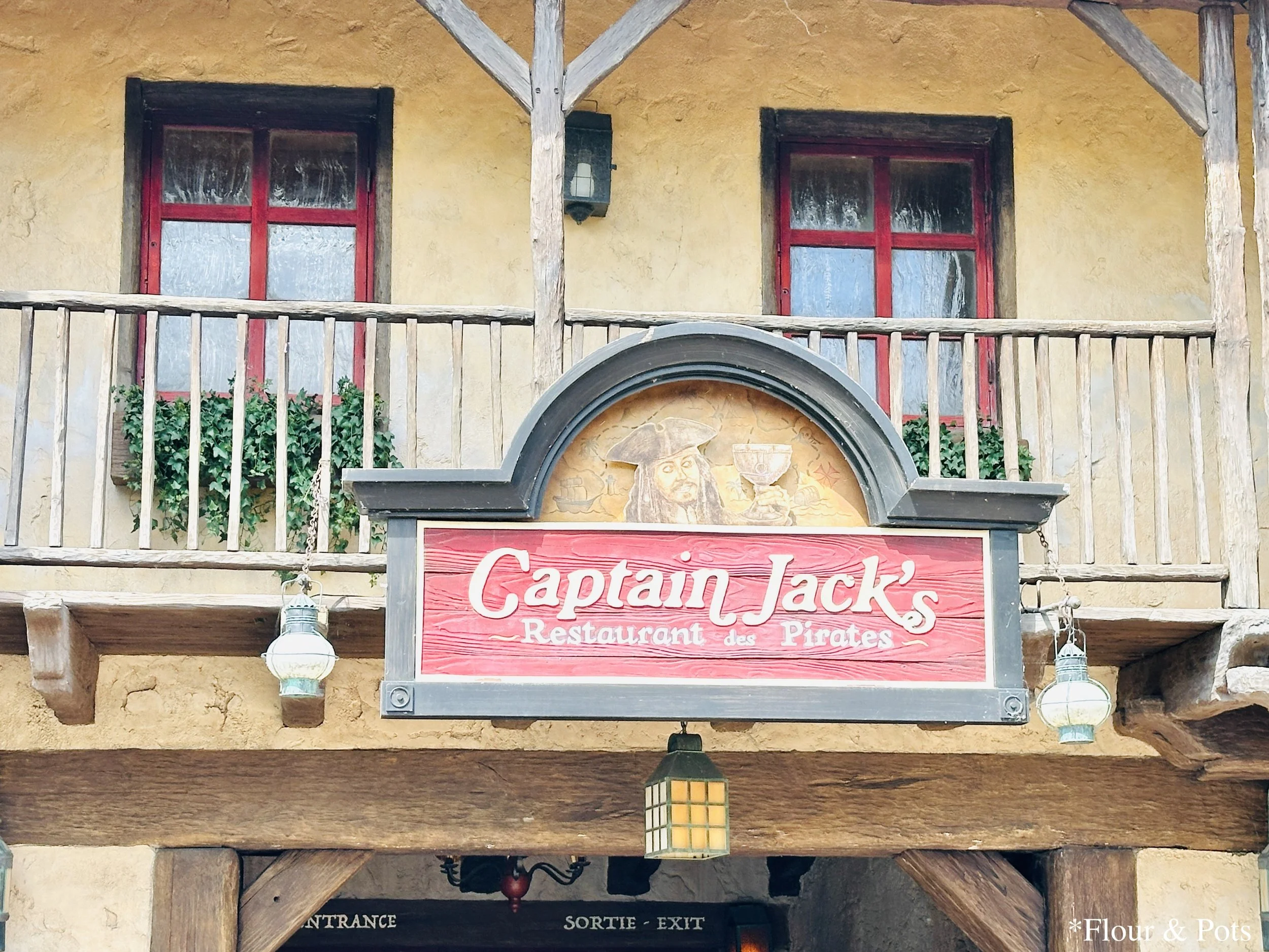 Entrance sign for Captain Jack’s Pirate Restaurant, a Caribbean-themed dining location at Disneyland Paris that requires reservations.