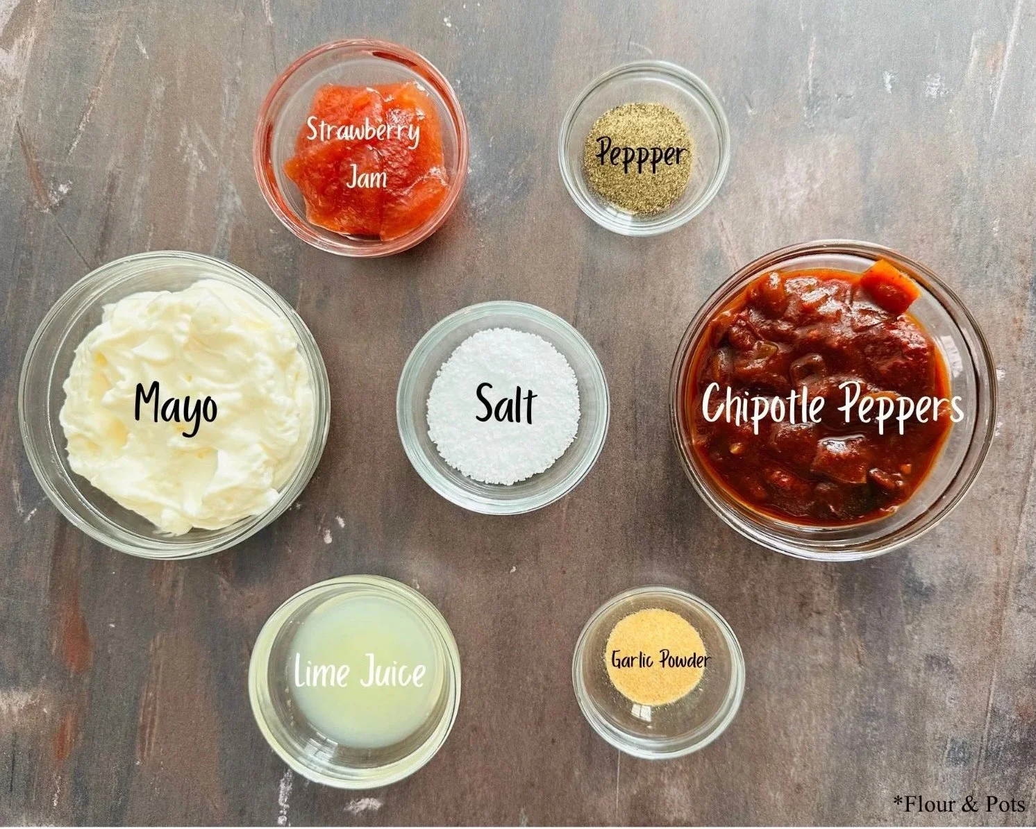 Ingredients for strawberry and chipotle mayo, including strawberry jam, lime, mayonnaise, and chipotle peppers in adobo sauce.