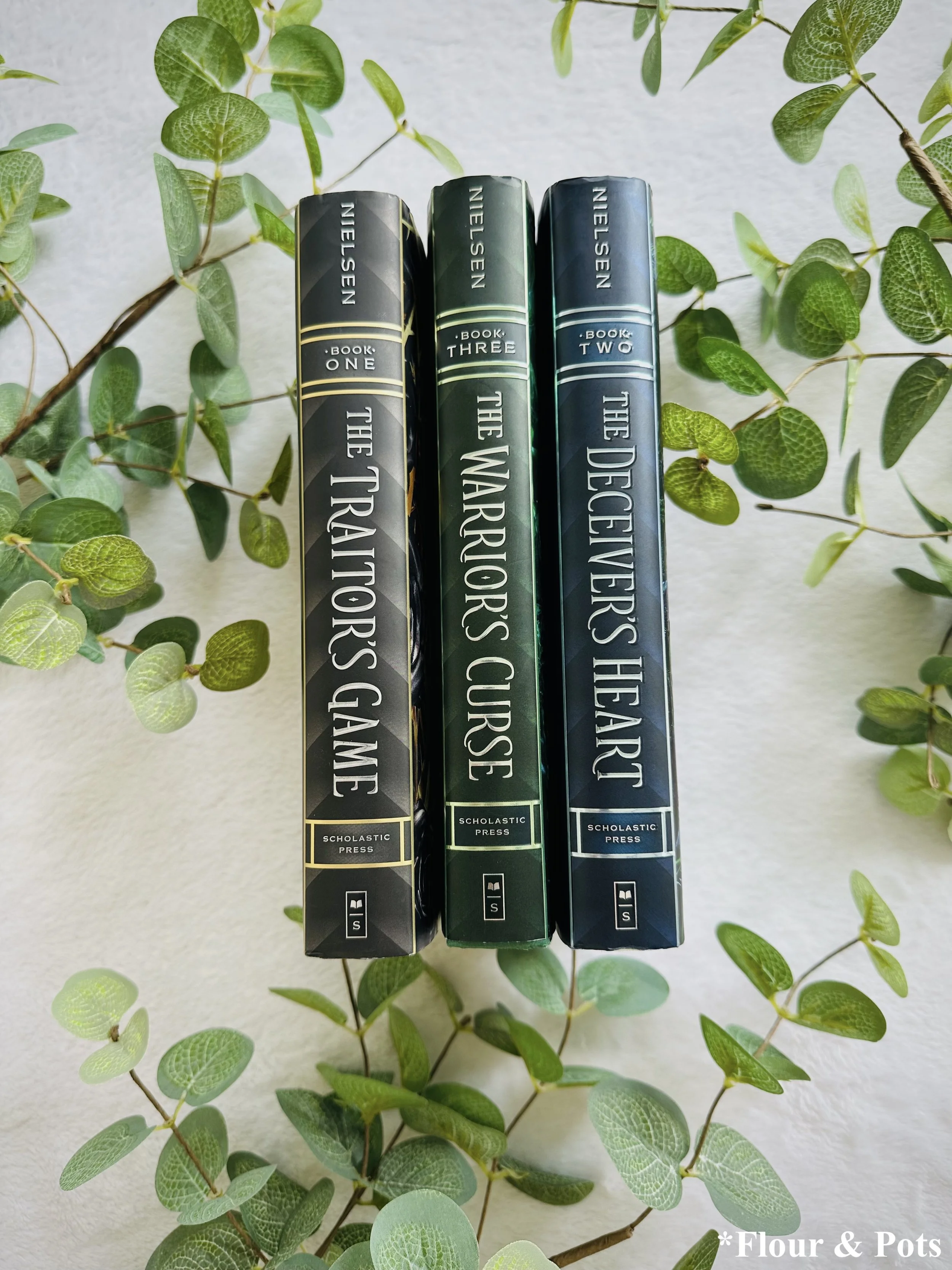 Jennifer A. Nielsen Traitor’s Game series displayed in a bold, adventurous reading setup