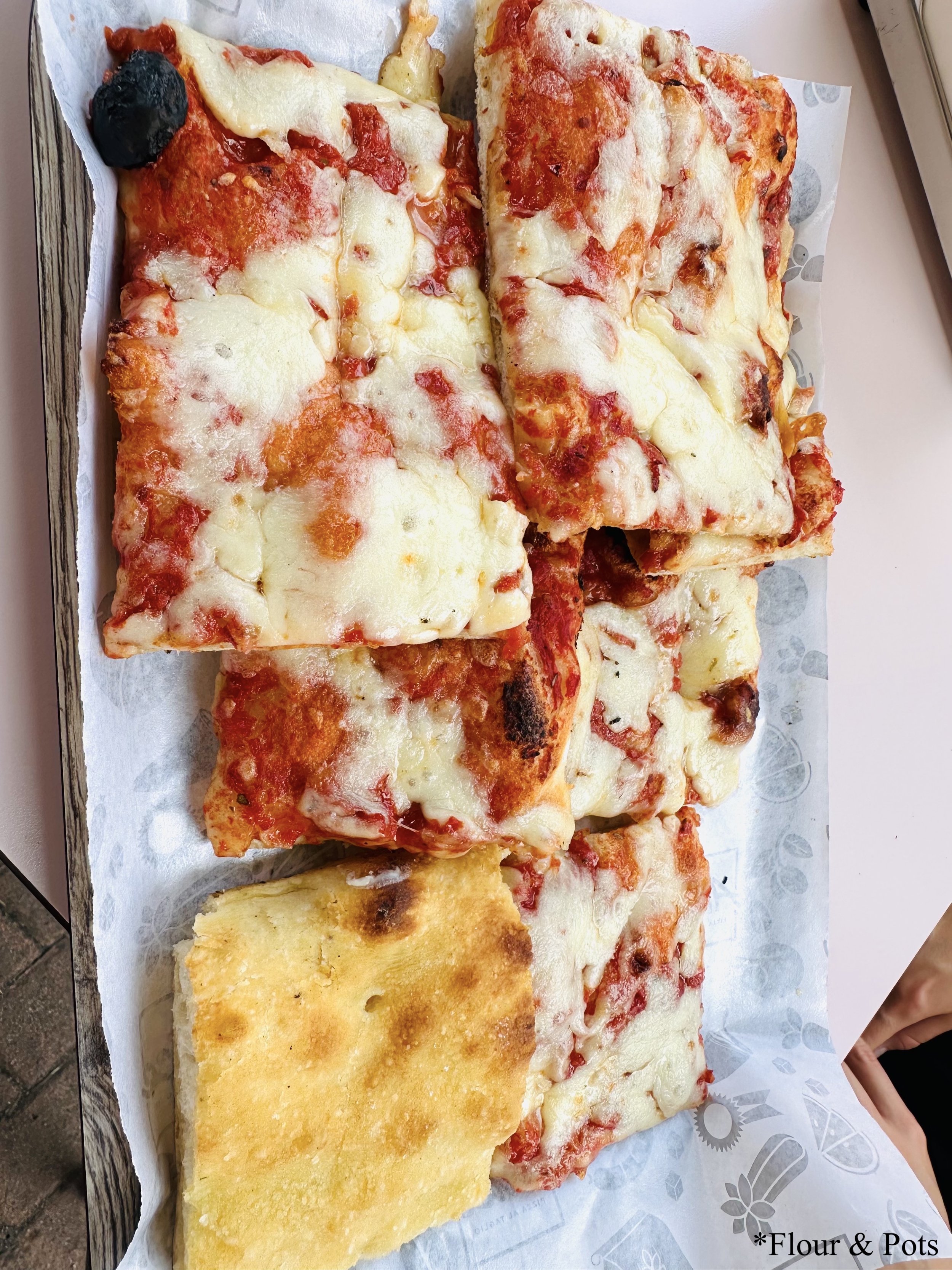 heese pizza from Alice Pizza in Rome, Italy — featuring a golden, crispy crust topped with rich tomato sauce and melted mozzarella cheese.