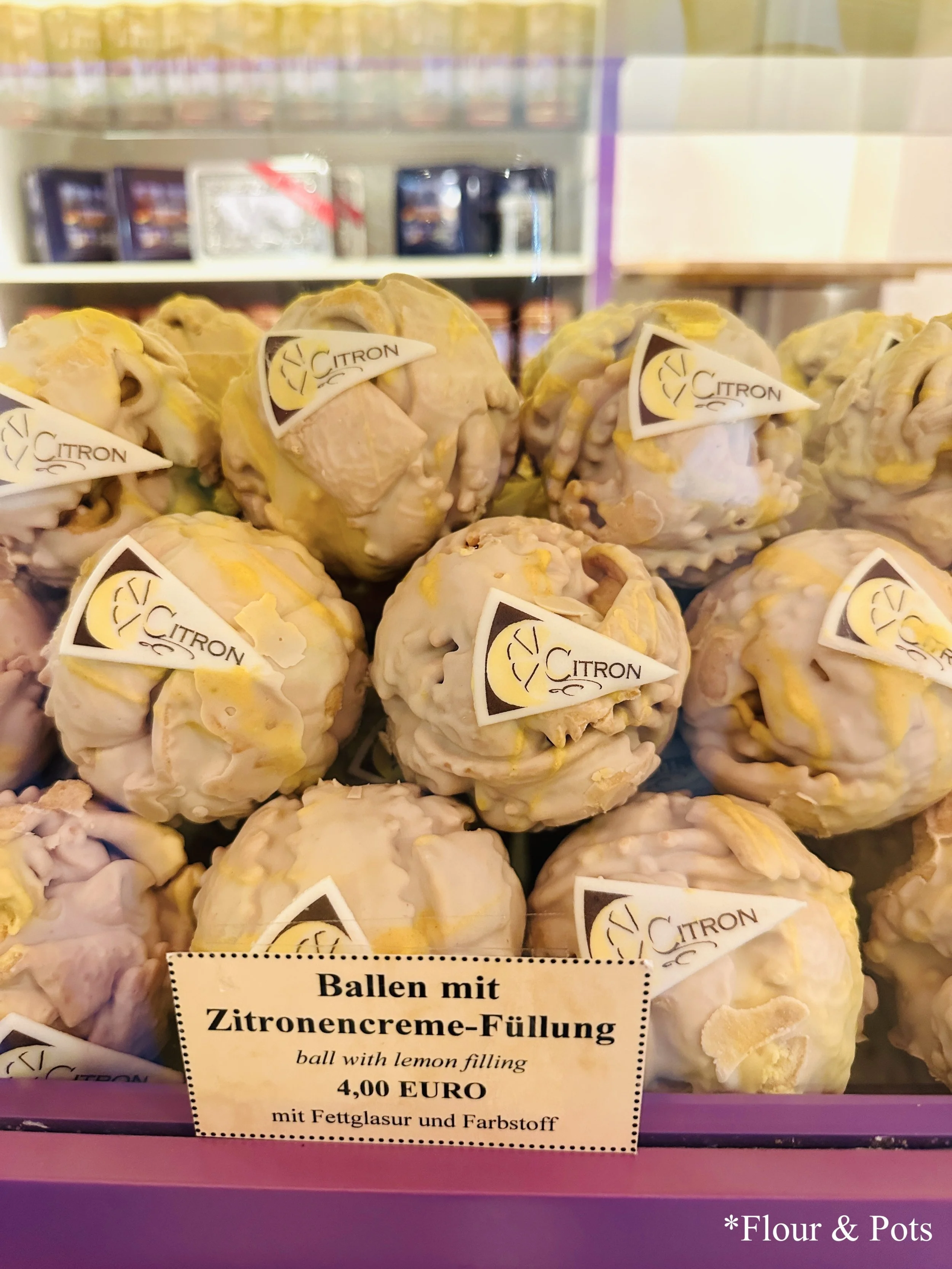 Close-up of lemon-flavored snowballs, a local dessert from Rothenburg, Germany, on display at a bakery.