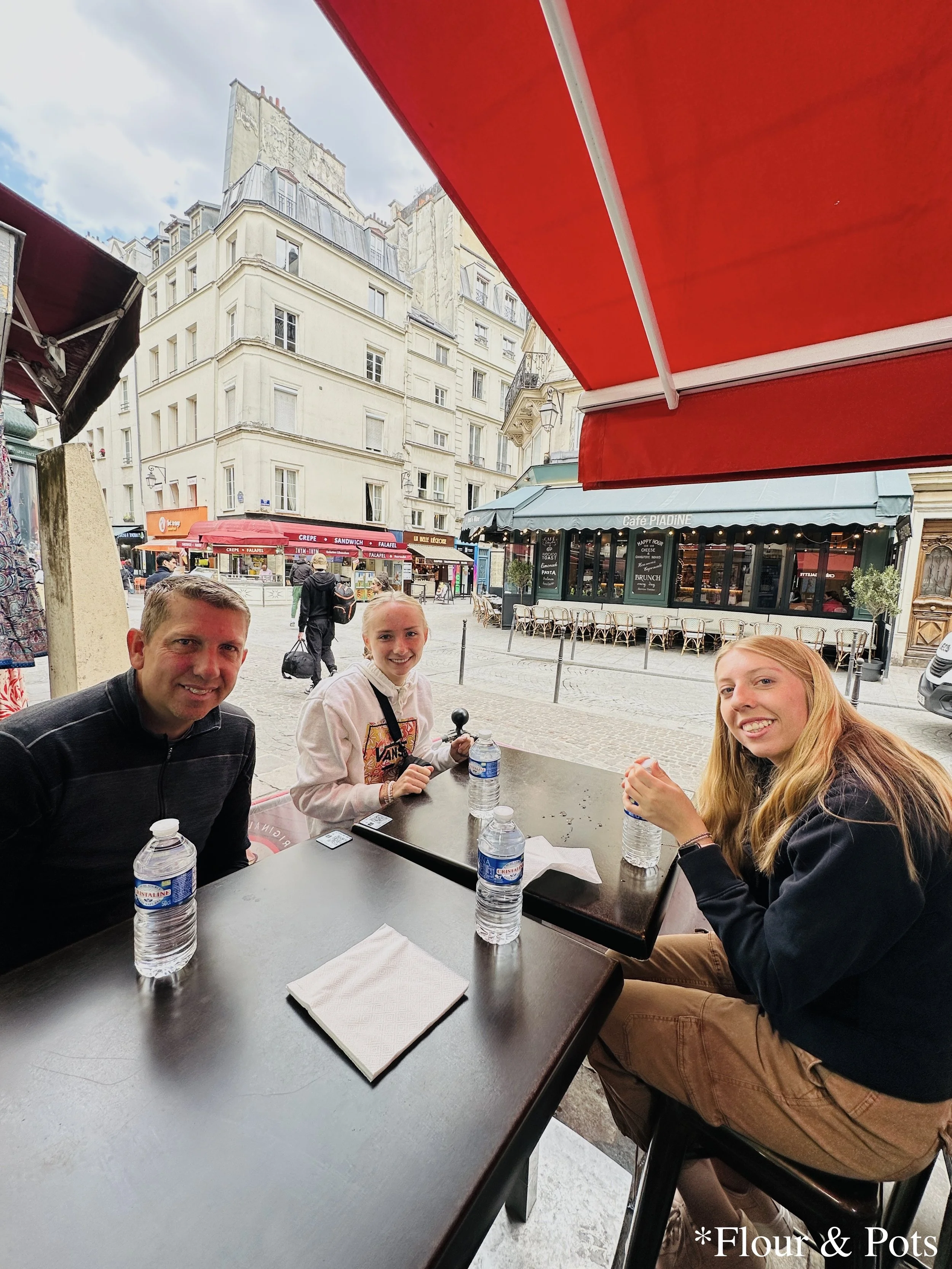 My family waiting for crêpes at Au P’tit Grec Crêperie in Paris, France.