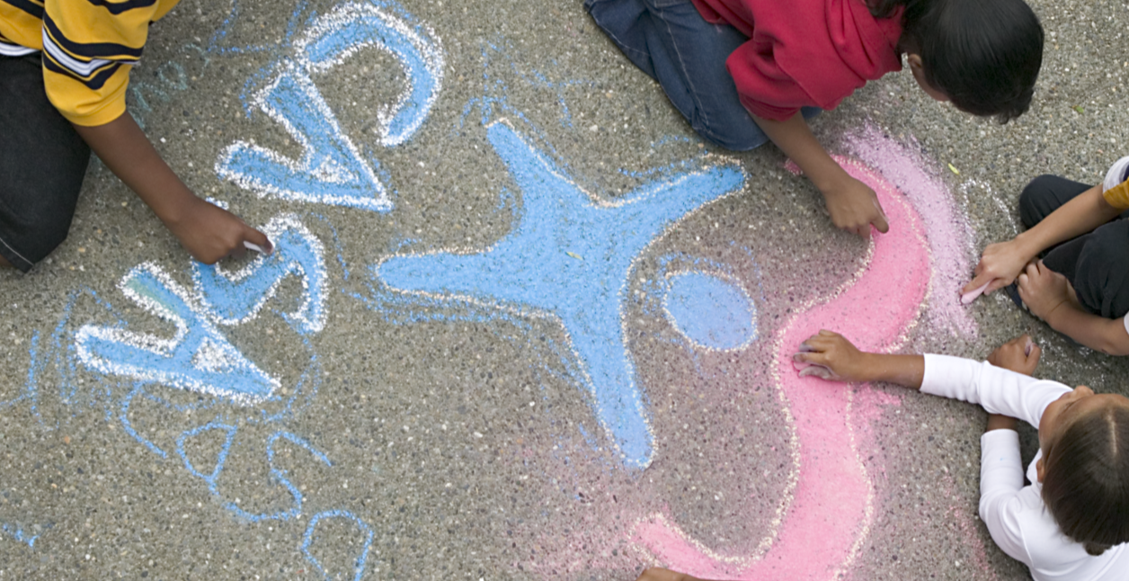 Kids drawing CASA and logo in chalk