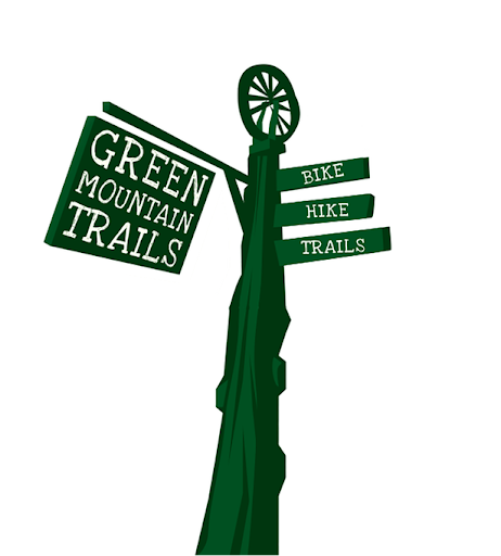 Signpost for Green Mountain Trails with directions for bike, hike, and trails, featuring a sunburst at the top