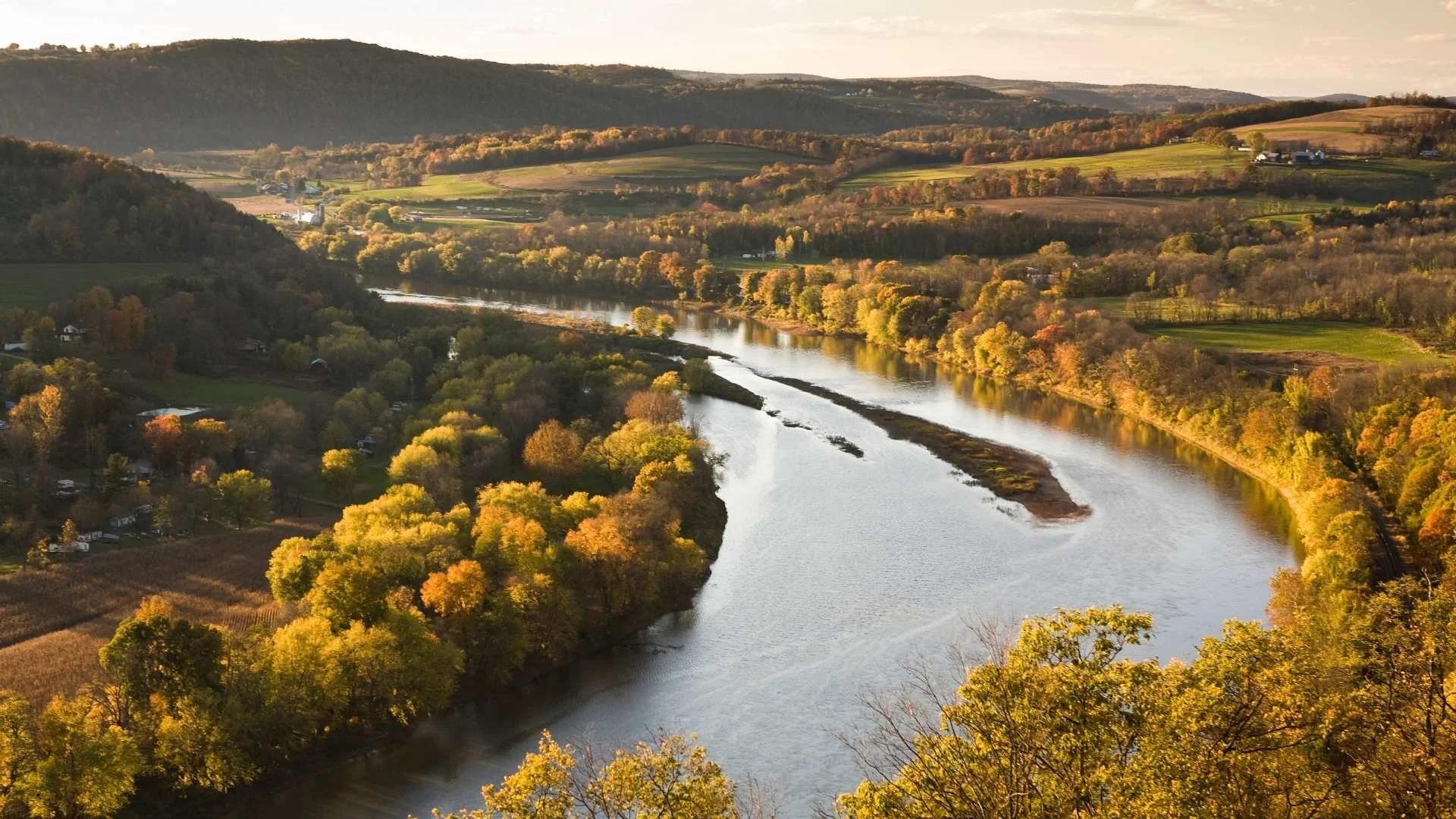 Aerial view of the Lehigh River winding through Pennsylvania fall foliage, ideal travel trailer camping country near Allentown