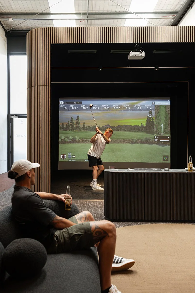 Small team enjoying an indoor golf Christmas function at Bunker Golf in Mount Maunganui