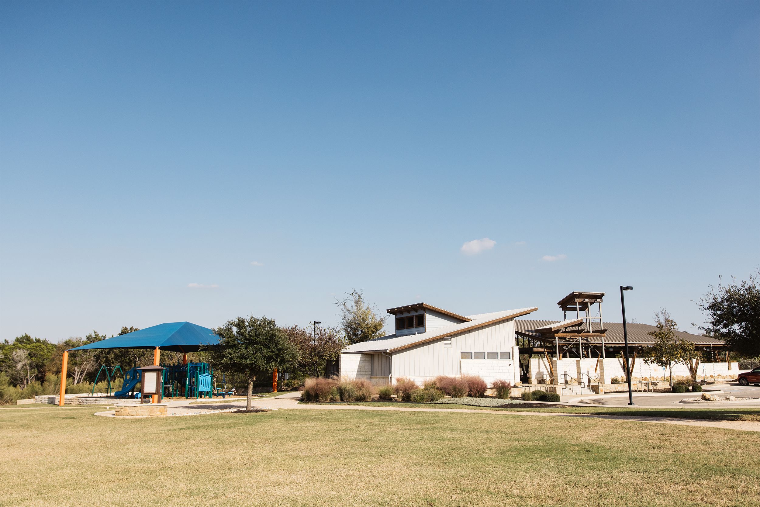 Community park with playground and modern building