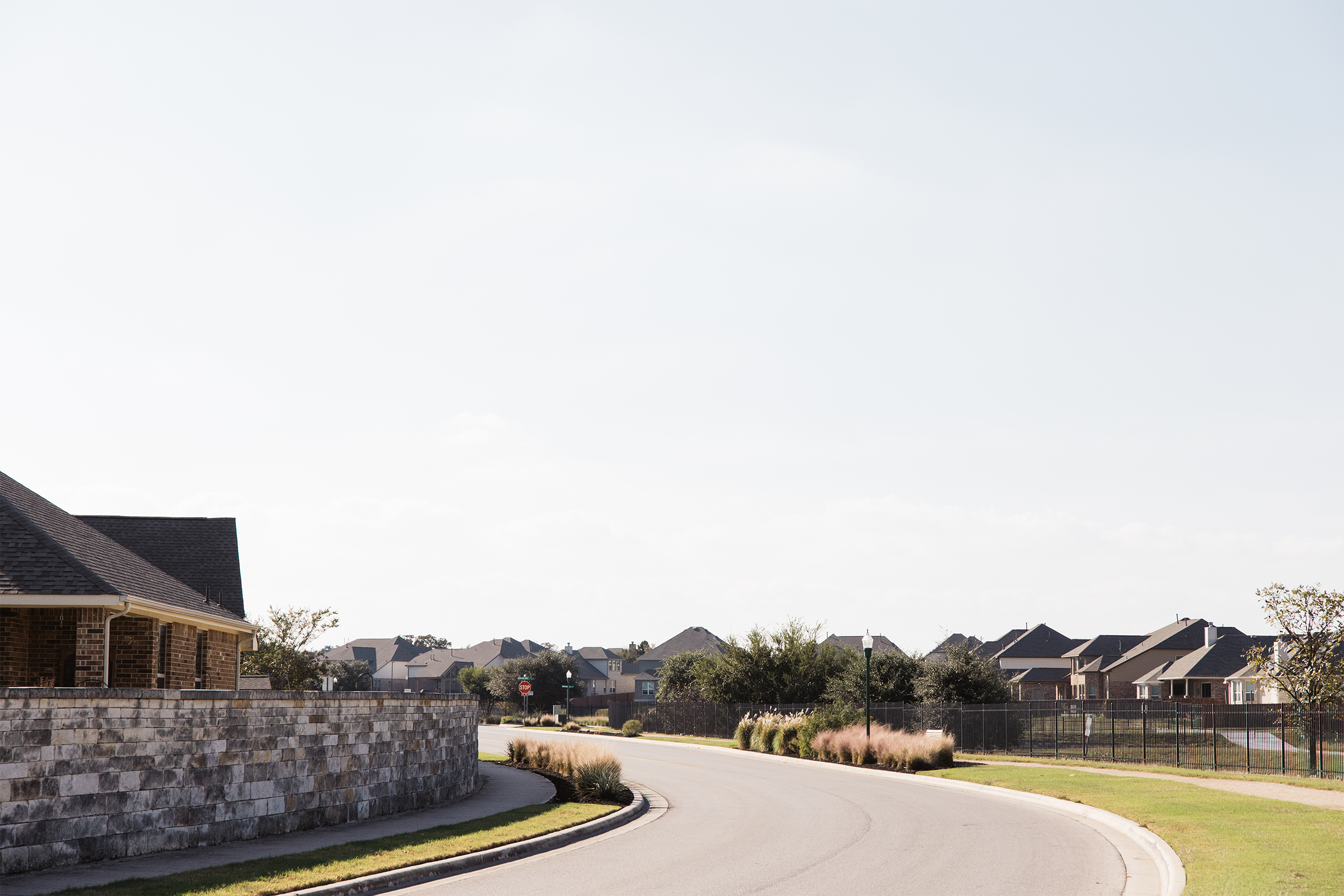 Suburban neighborhood street with houses and a curved road