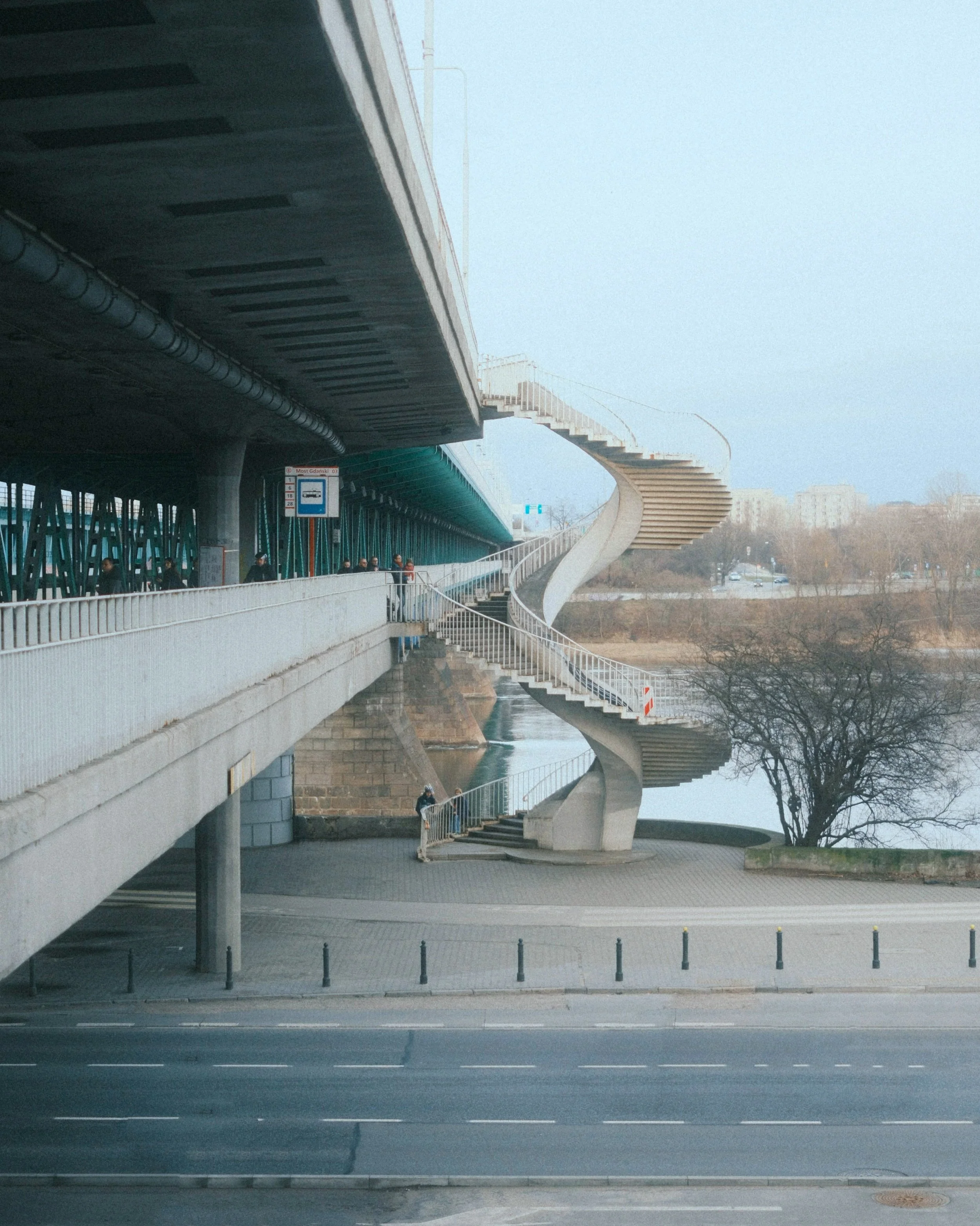 A spiraling bridge connecting to a highway crossing