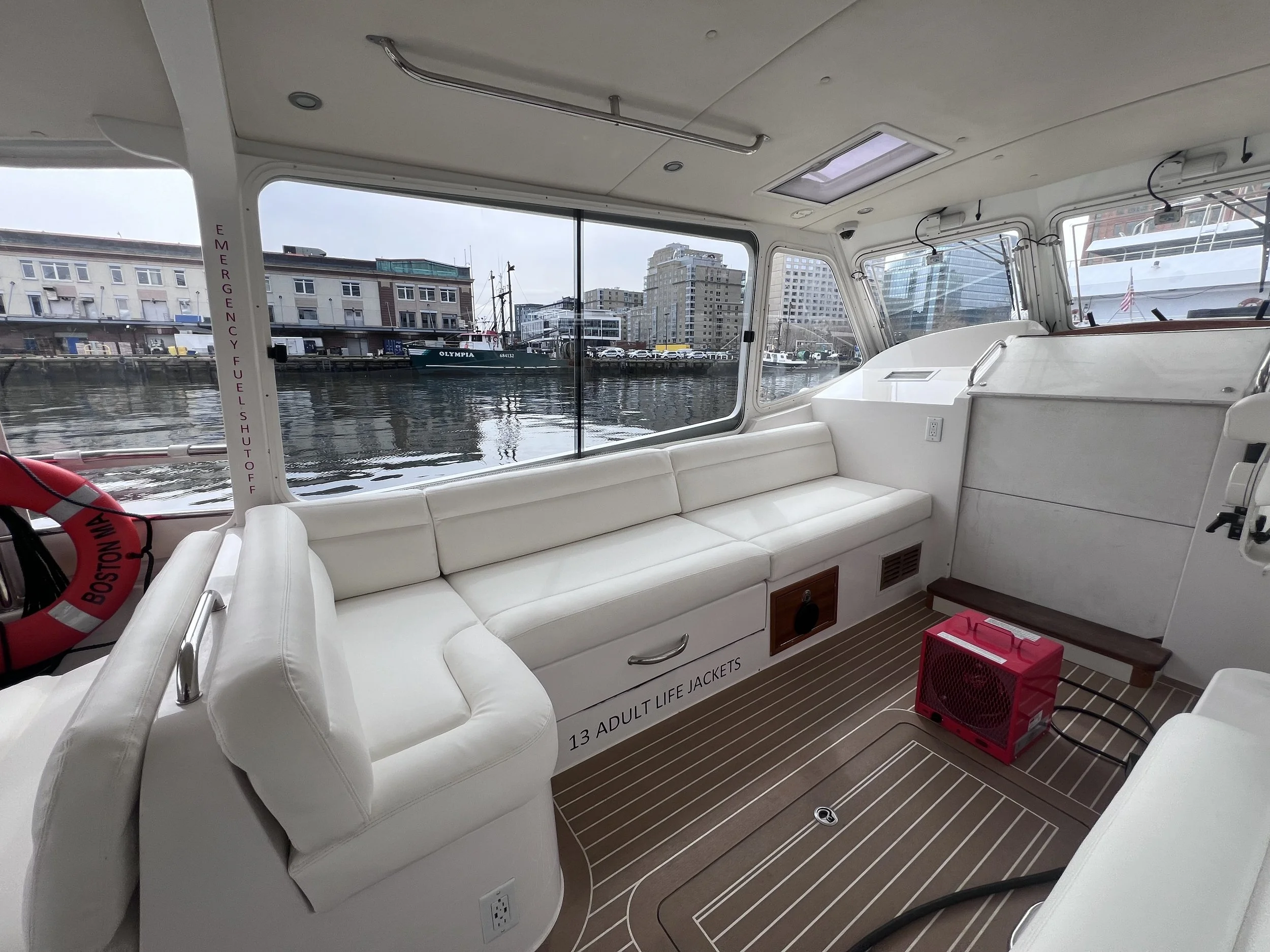 Custom marine cover protecting a boat, designed with high-quality, durable marine-grade material for maximum weather resistance and longevity.