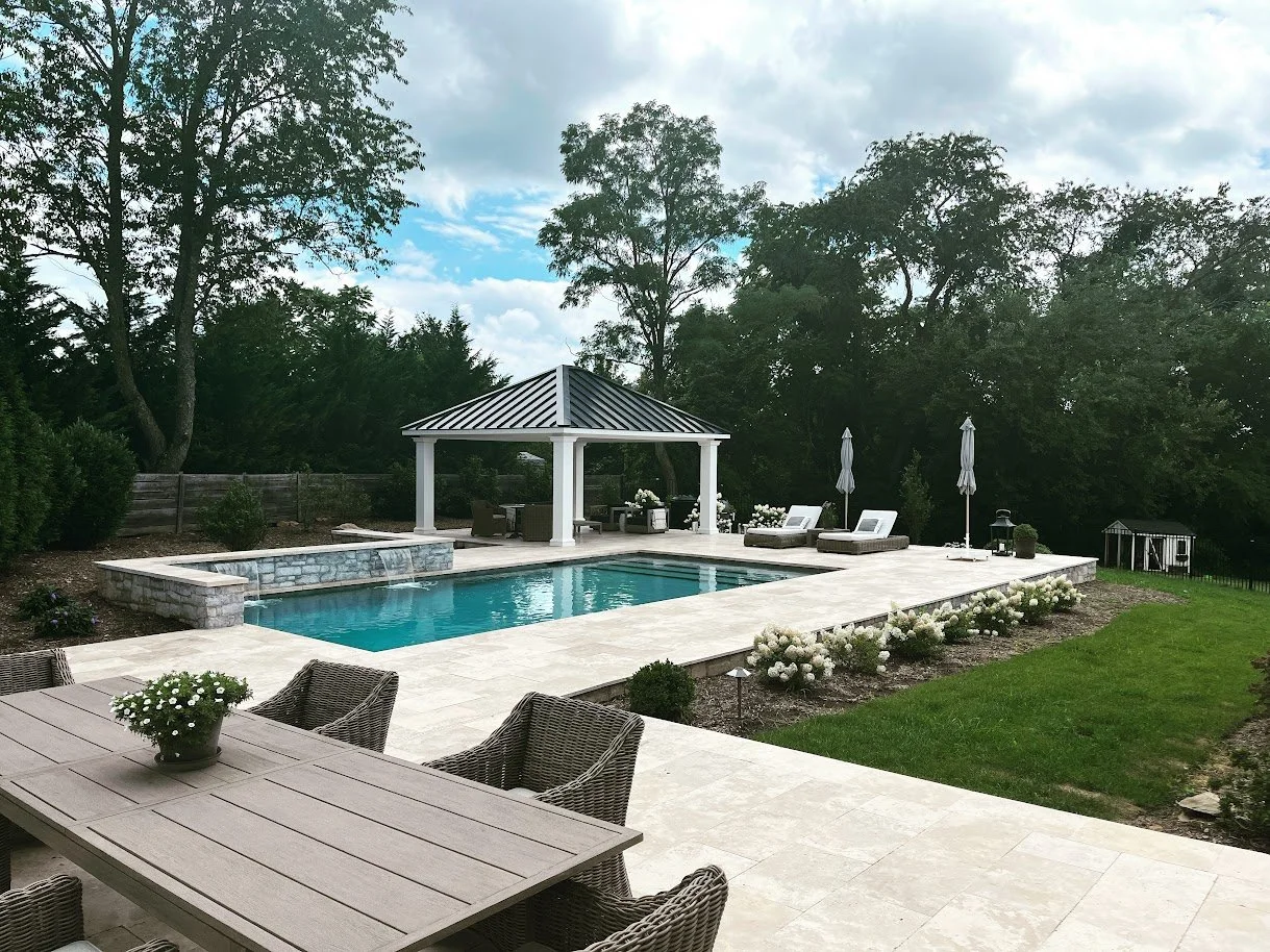 Gunite pool with raised wall, waterfalls, and pavilion in Middletown, MD.