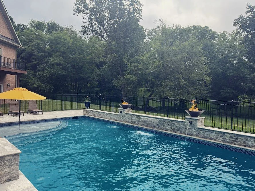 Gunite pool/spa combo with waterfalls, fire bowls, and automatic cover in Dayton, MD.