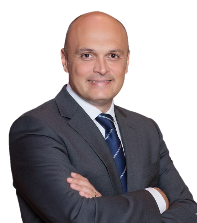 A bald man wearing a dark suit, white shirt, and striped tie, smiling with arms crossed, isolated on a transparent background.