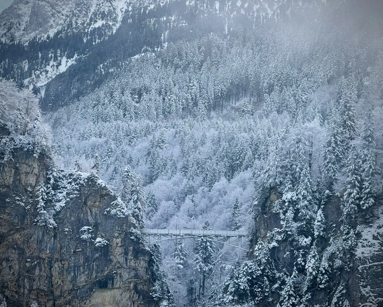 Marienbrücke, or Queen Mary’s Bridge, is visible in between bouts of fog during a winter visit to Neuschwanstein Castle. Adventuresome Co. photo.