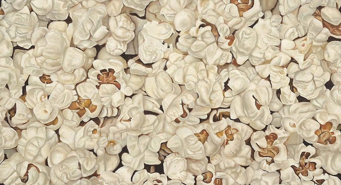 Ci sono molti popcorn bianchi sparsi su una superficie.