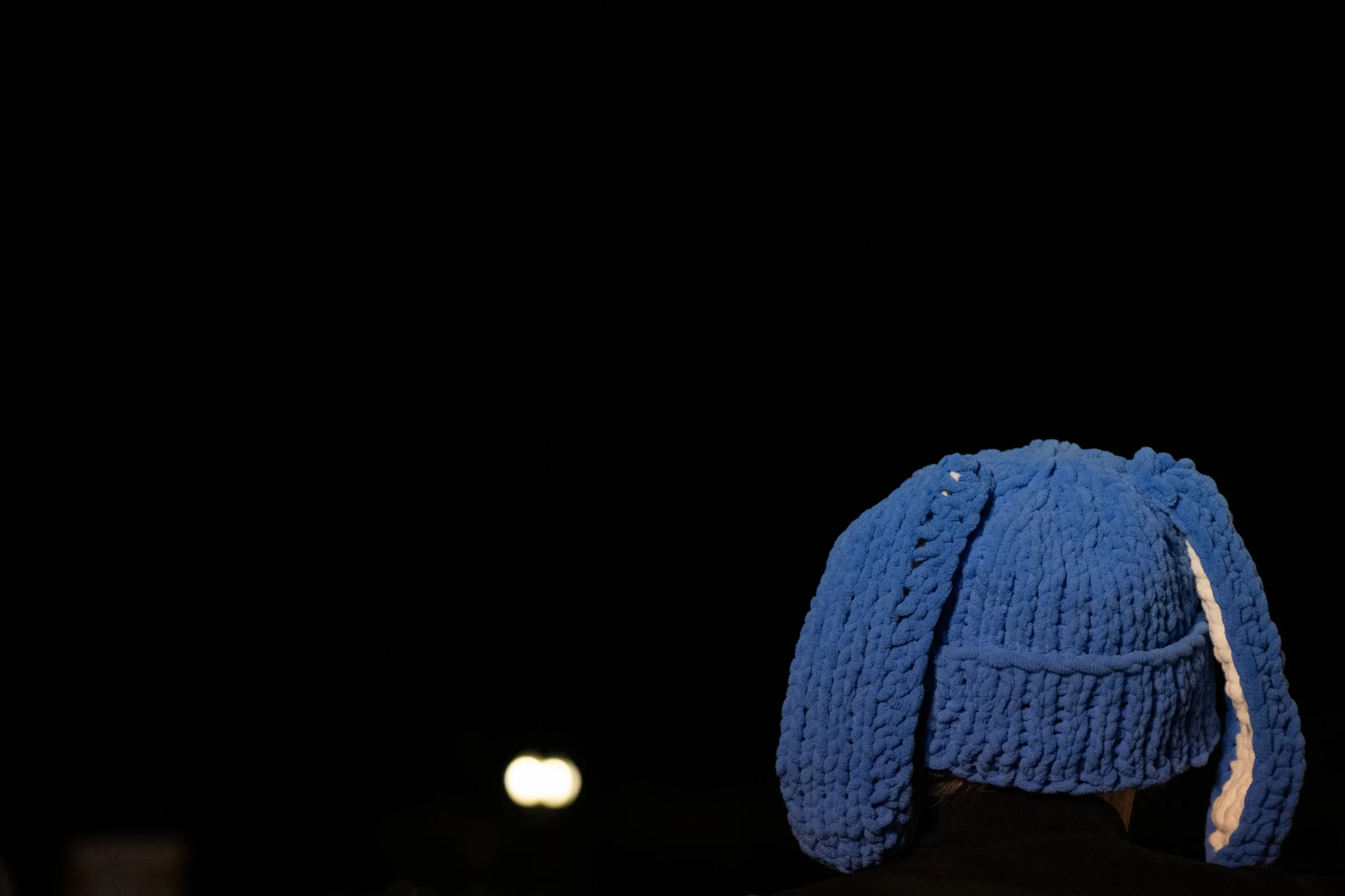 A spectator wearing a blue knit hat similar in style to one worn by 5-year-old Liam Conejo Ramos, who was detained by U.S. Immigration and Customs Enforcement, stands outside the United States Capitol during the “People’s State of the Union” event on
