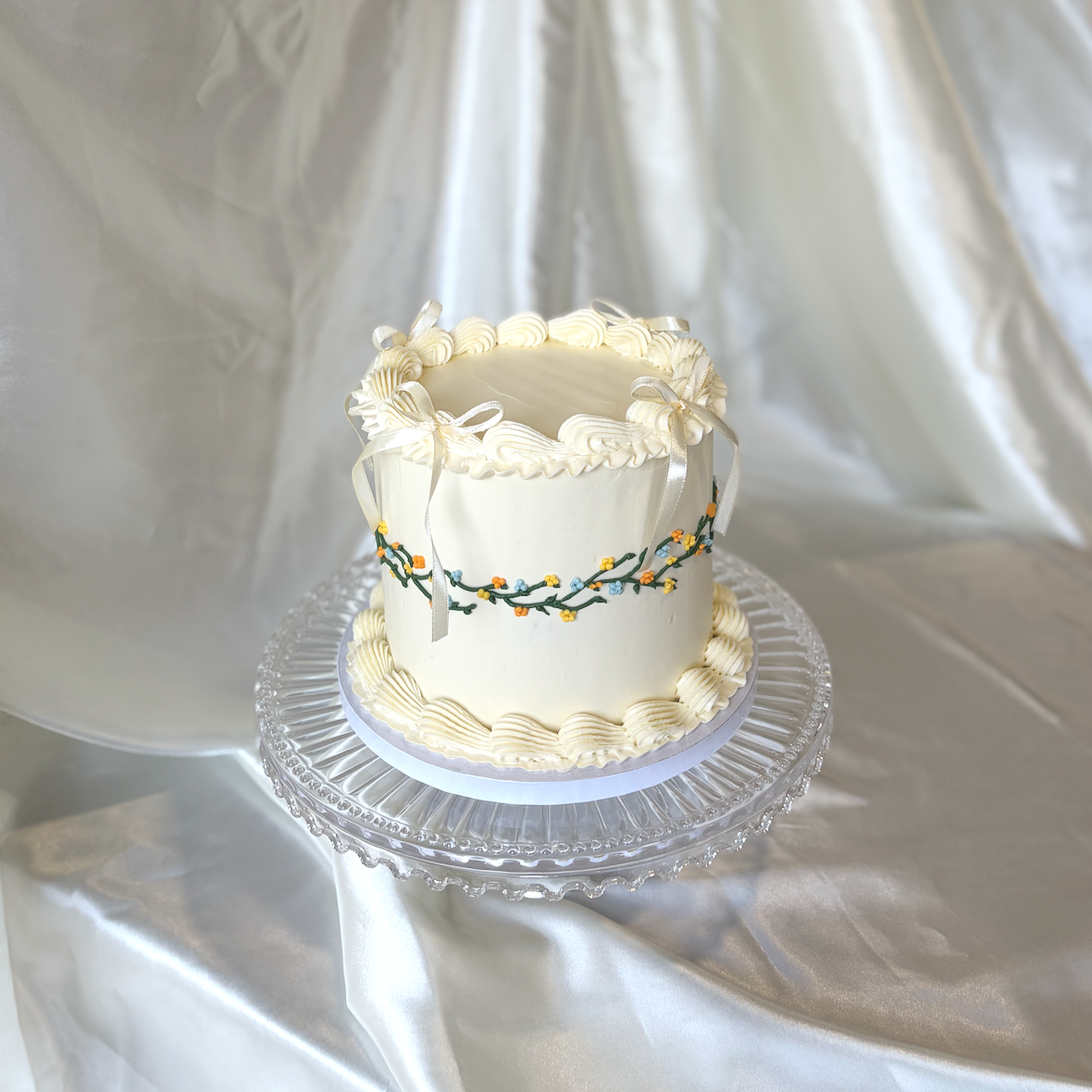 Vintage cake with flower and vine details and bows