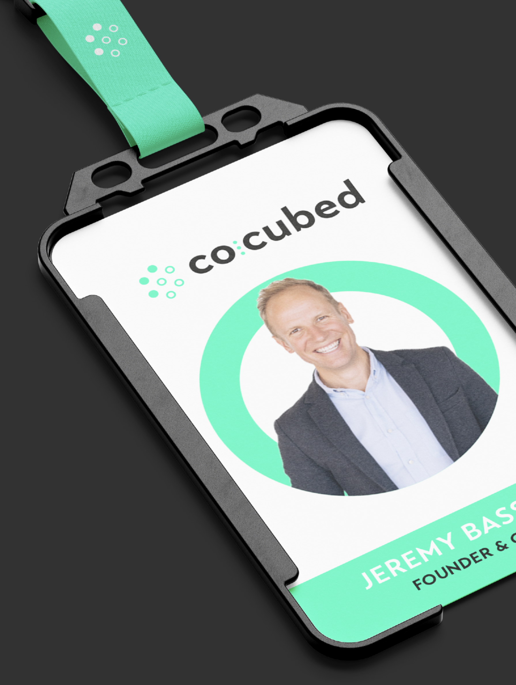 CoCubed office ID card attached to a green lanyard matching the company branding.