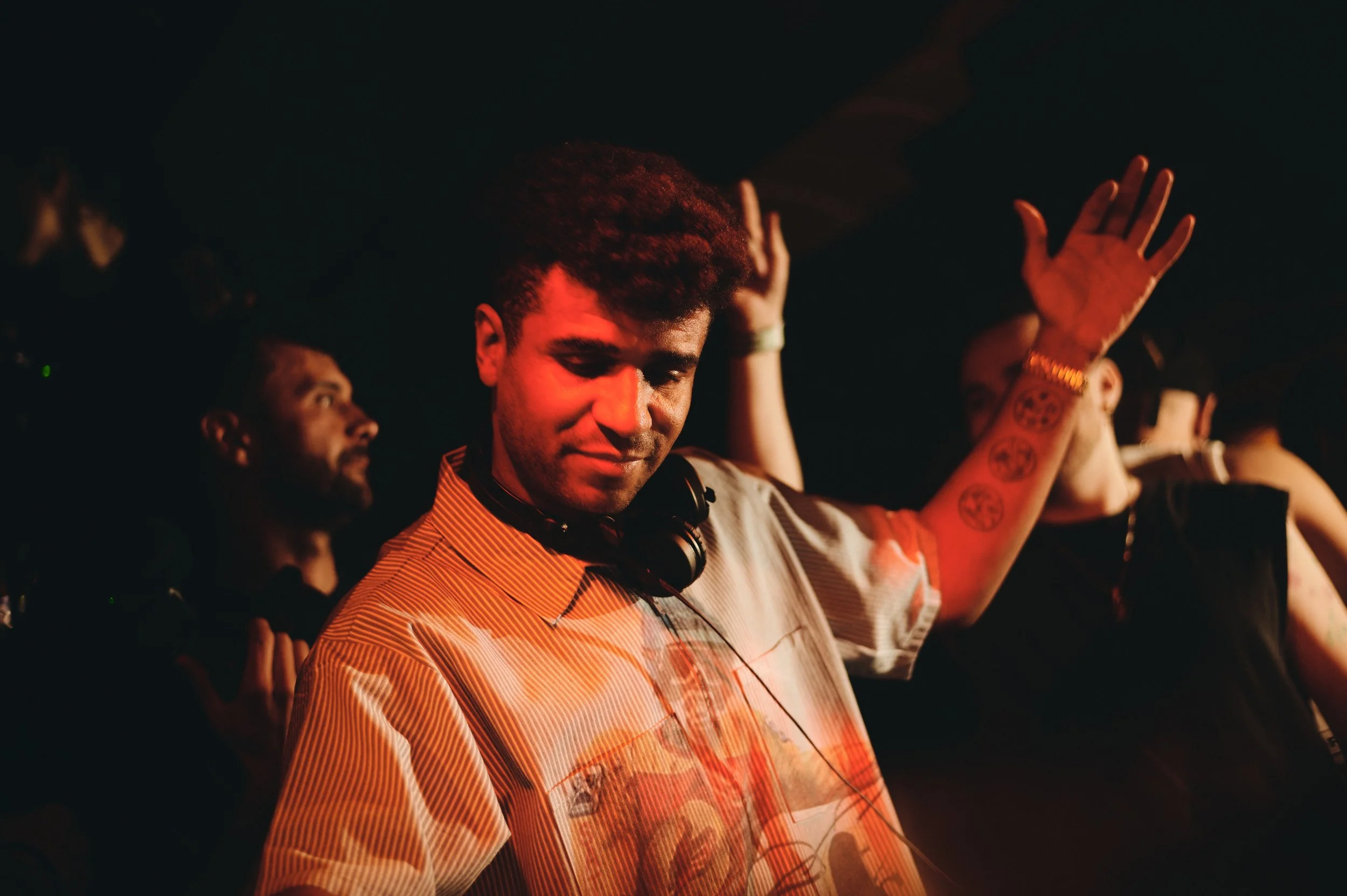Jamie Jones performing a live DJ set in a large Ibiza nightclub, surrounded by vibrant lights, energetic crowd, and immersive club atmosphere.