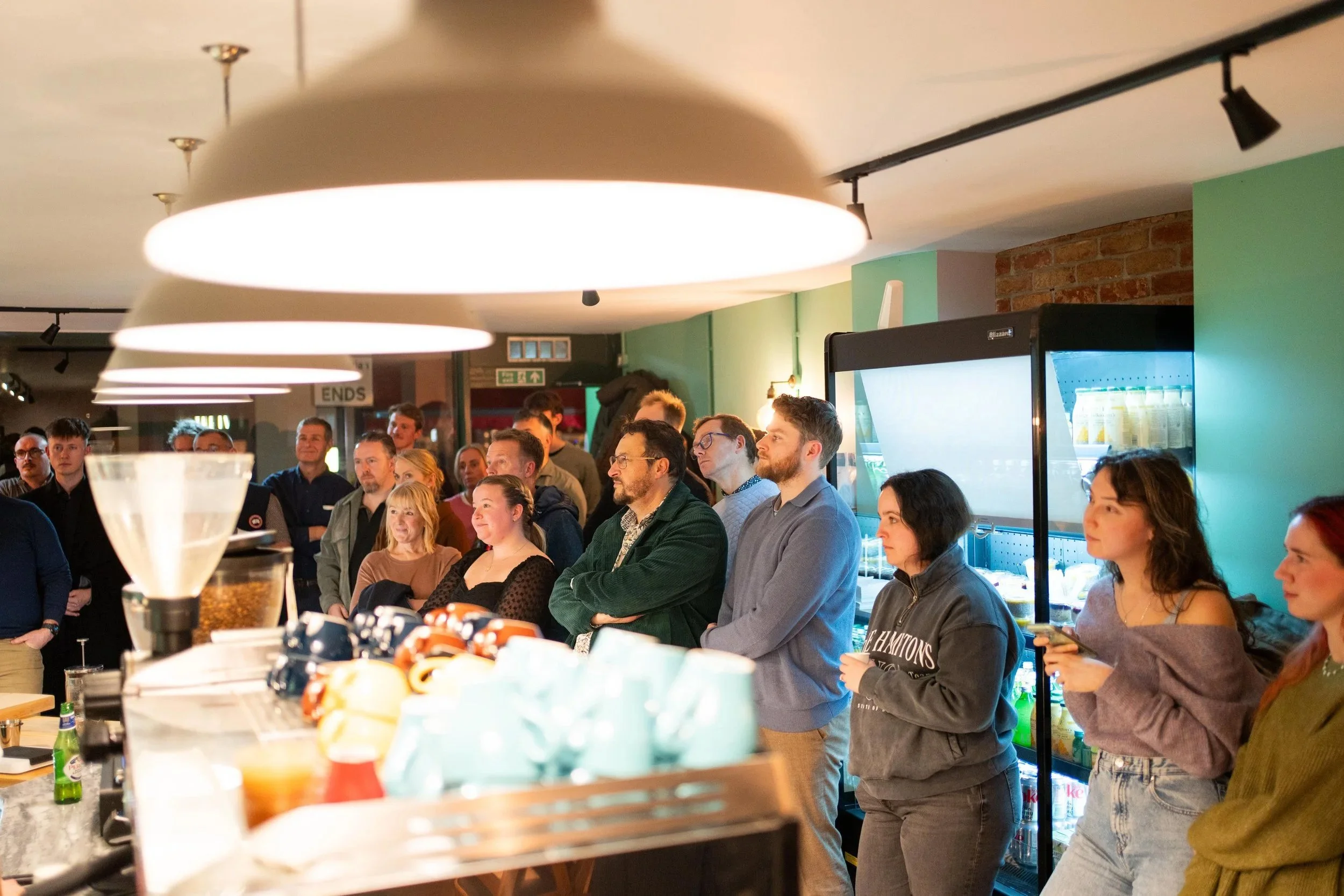Packed room at a Sorrel Social event with an attentive audience looking inquisitively at the speaker.