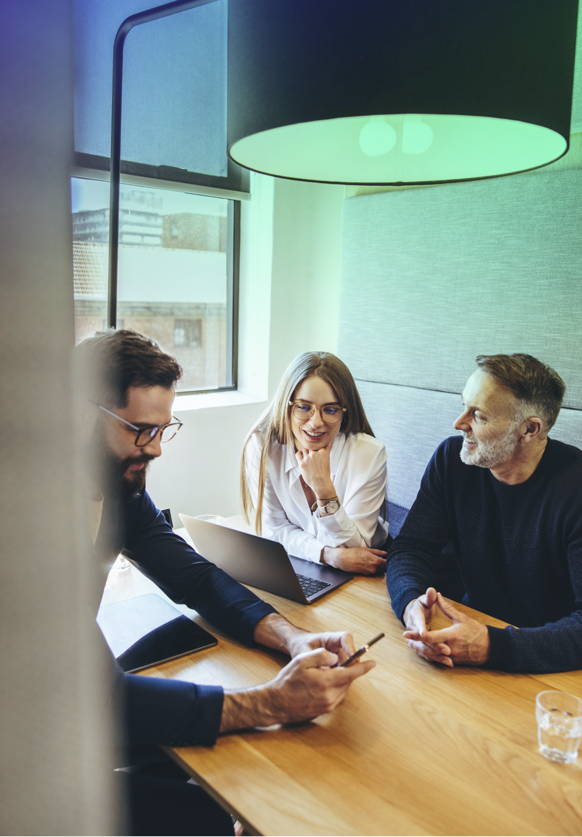 CoCubed employees sitting together and chatting in the office environment.