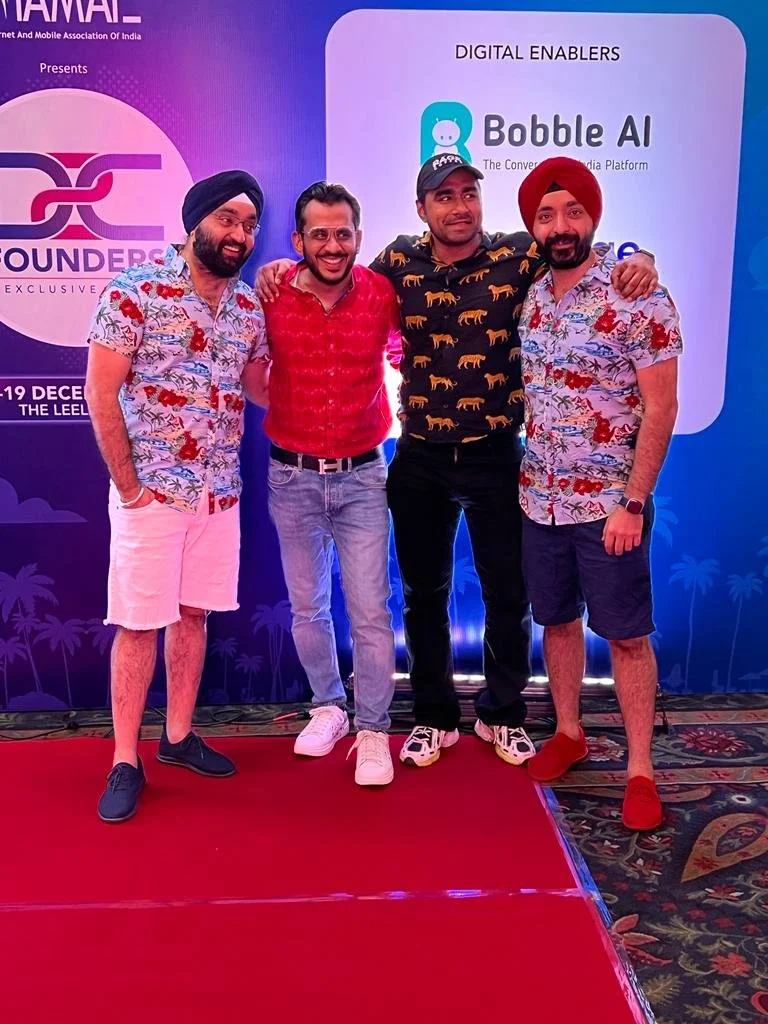 Four men standing together on a red carpet at an event, with a backdrop displaying the logos for Bobble AI and other sponsors.