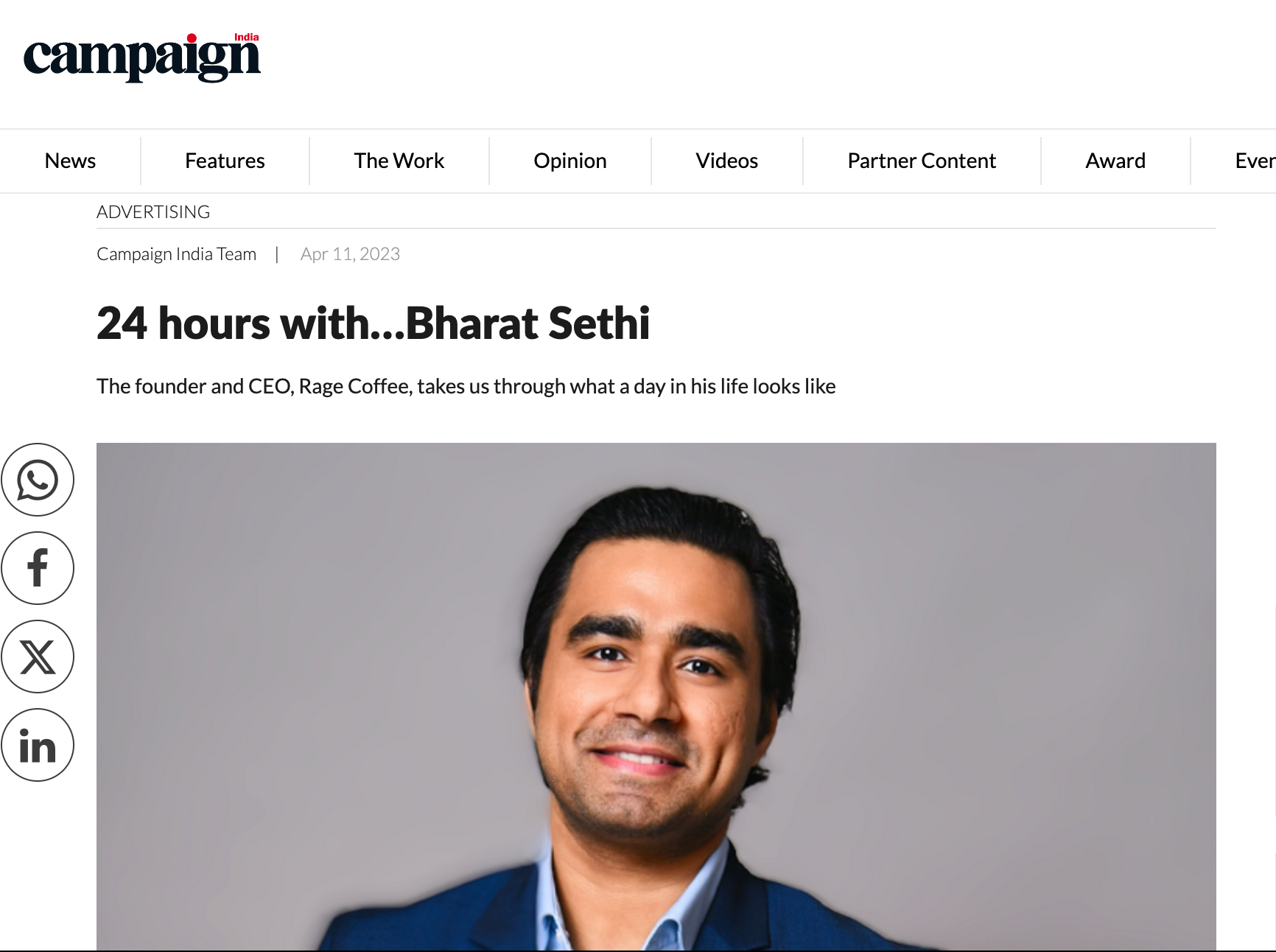Portrait of Bharat Sethi, founder and CEO of Rage Coffee, smiling in a blue blazer and light blue shirt against a plain background.
