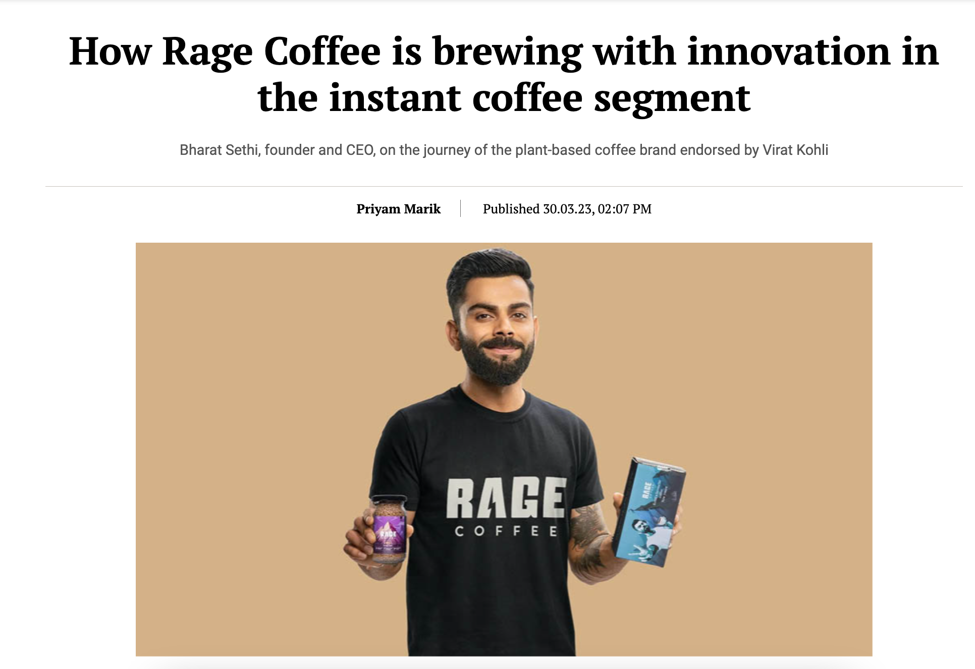 A man with a beard and black hair smiling, wearing a black T-shirt with the words "RAGE COFFEE" on it. He holds a jar of coffee in his right hand and a product box in his left hand, set against a beige background.