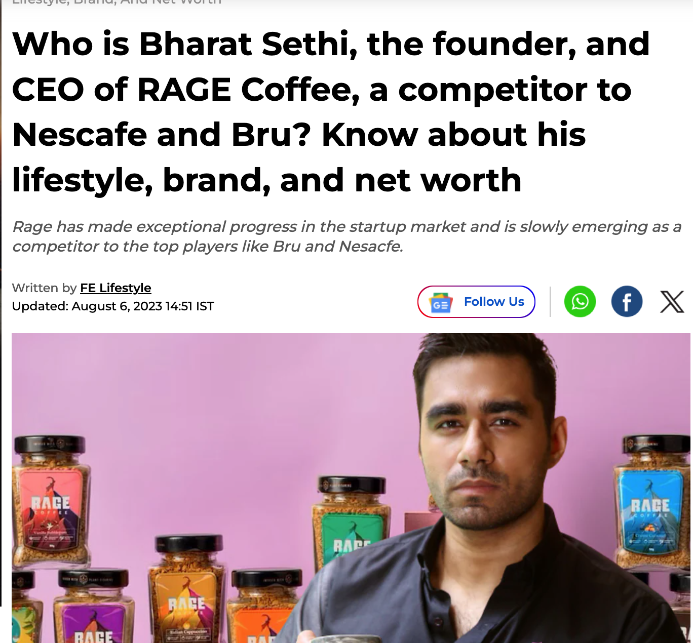 Man with short dark hair and dark collared shirt standing in front of shelves with jars of Rage Coffee against a pink background.