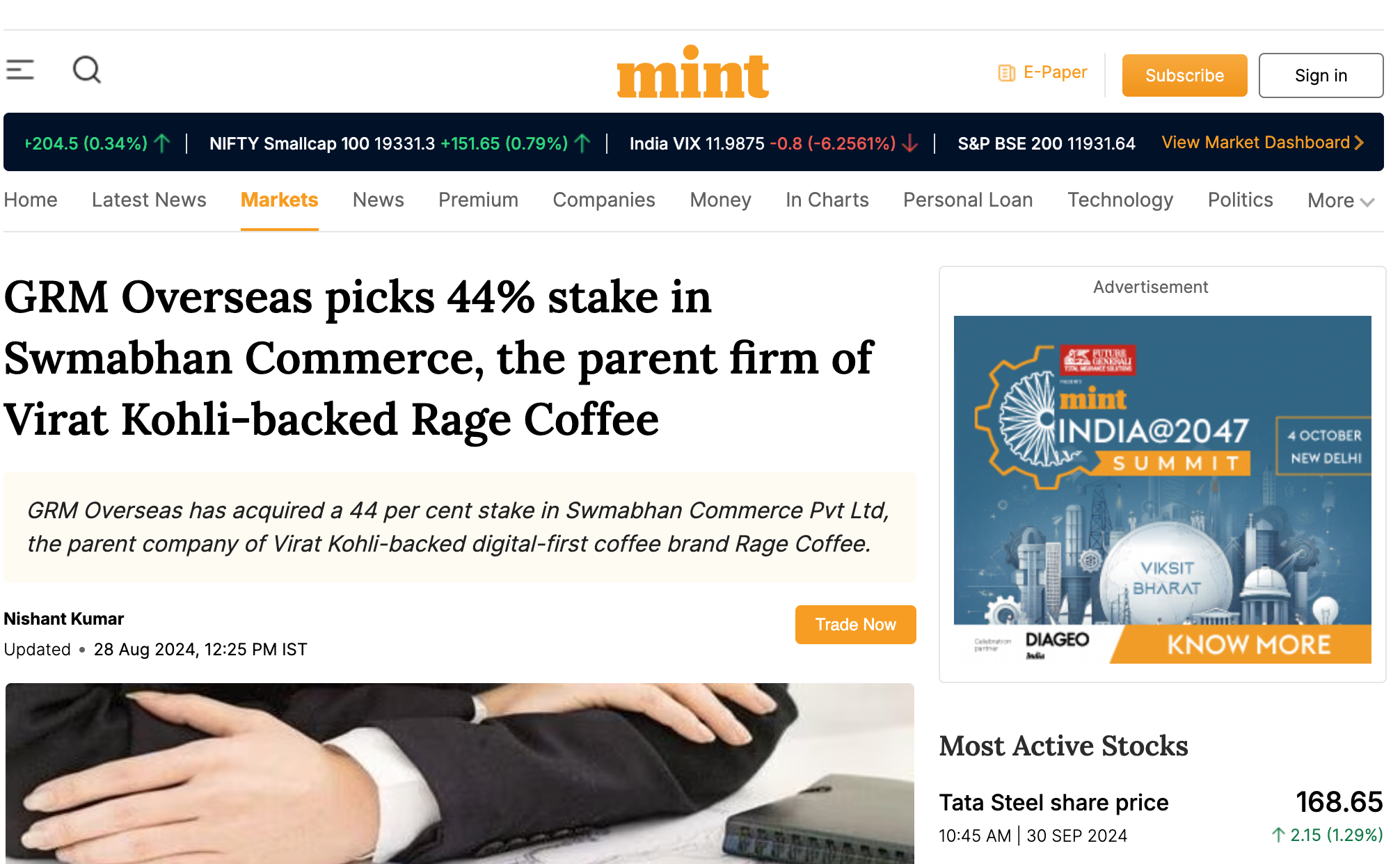 A screenshot of a financial news website with a headline about GRM Overseas acquiring a stake in Swambhan Commerce, and an advertisement on the right side for the 'India@2047 Summit' in New Delhi.