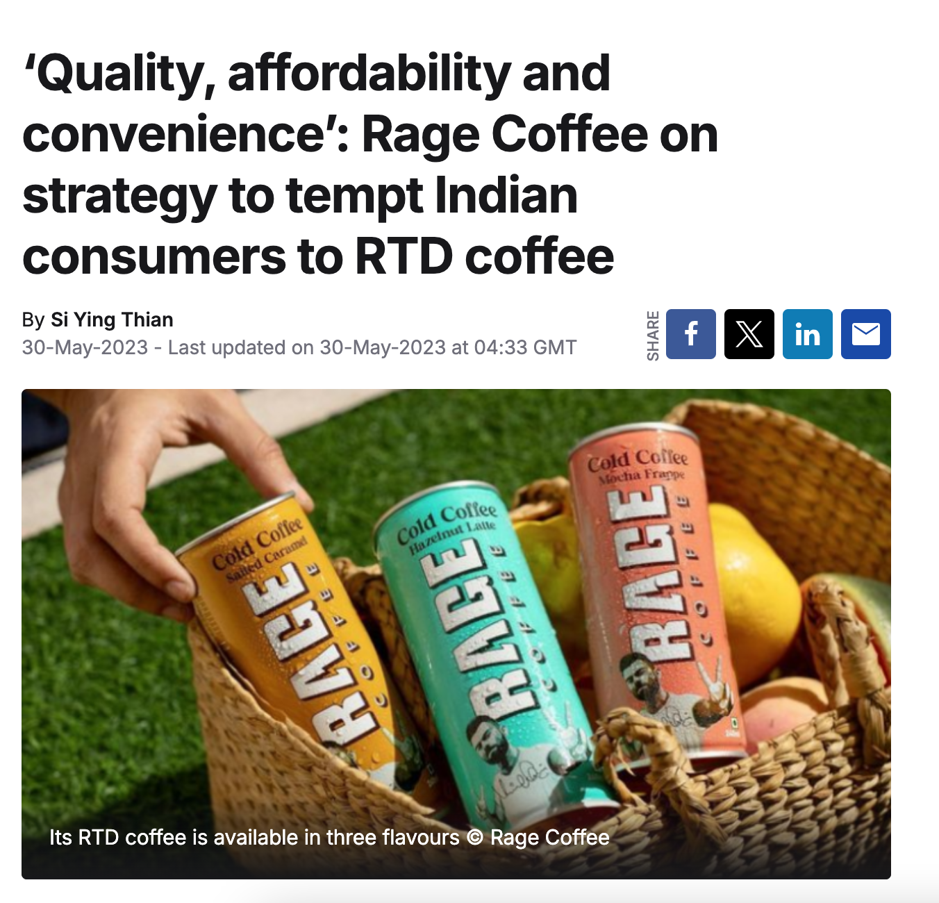 Three canned Cold Coffee drinks in a wicker basket, held by a person's hand, with peaches and greenery in the background.