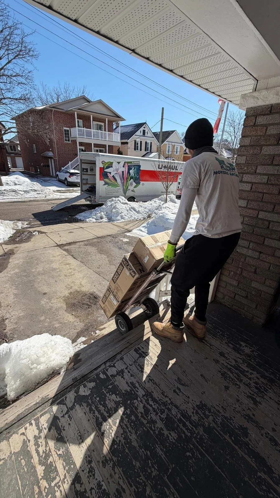 Movers carrying moving boxes during a home move in Waterloo Ontario
