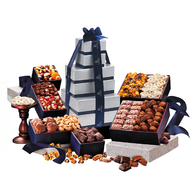 Assorted chocolates and candies in decorative boxes, arranged with a stack of gift boxes tied with ribbons.