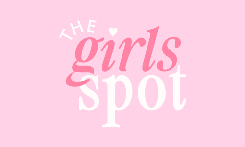 Pink background with the text 'The girls spot' in stylish pink and white lettering, and a small heart above the letter 'i'.