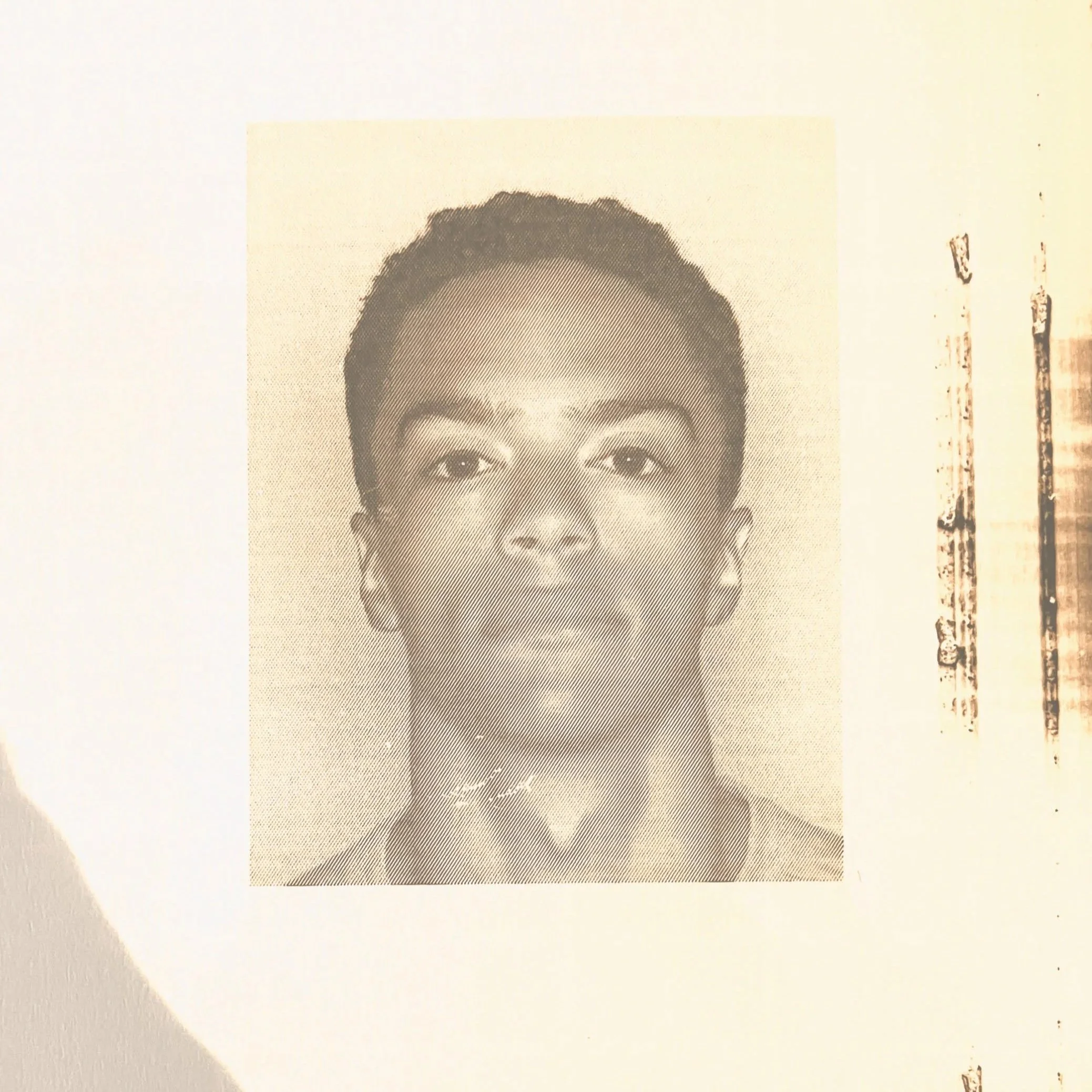Black and white headshot photograph of a young man with short hair.