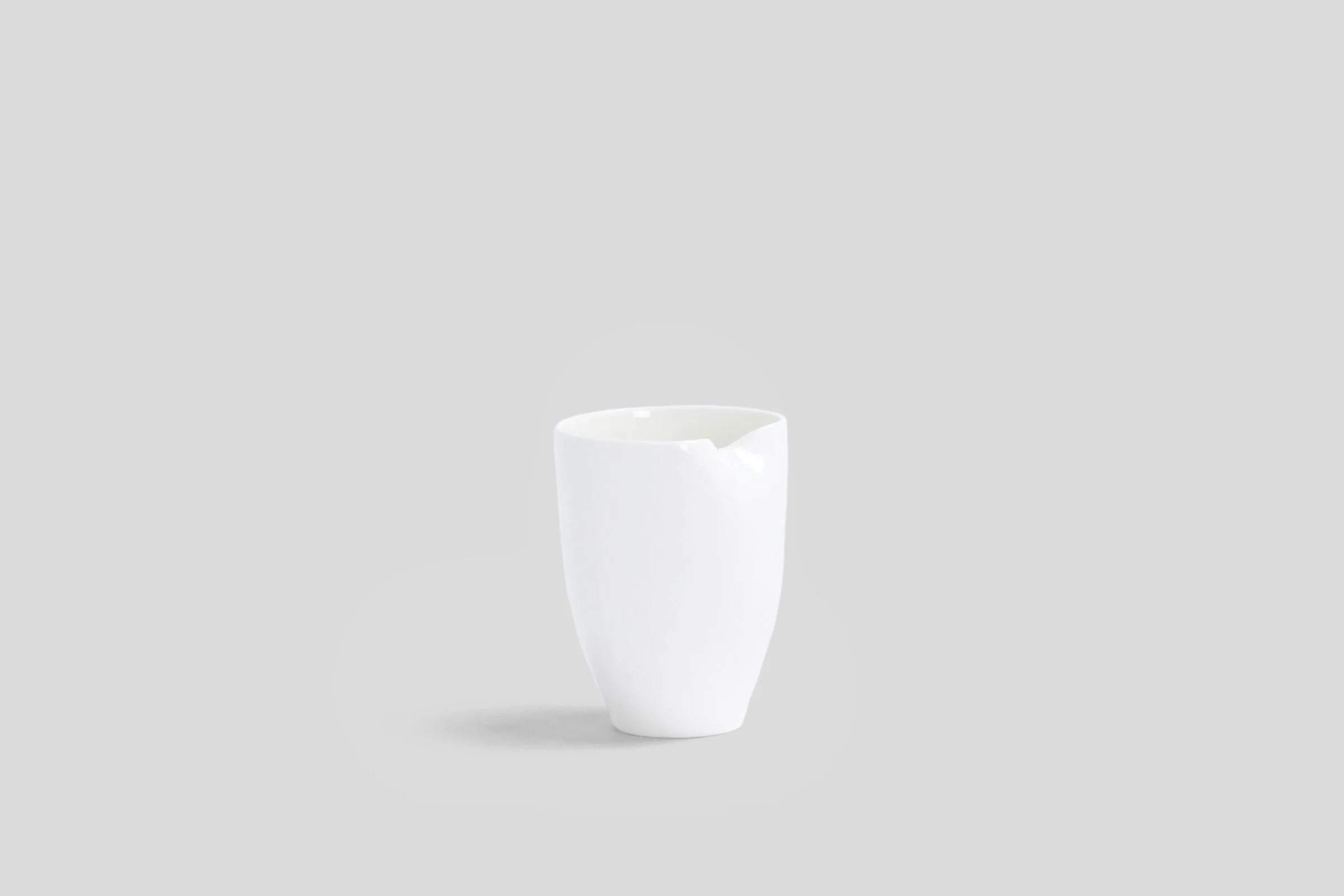 bodo_sperlein_white_sculptural_beaker_dented_2_copy_d783d5c4-e503-4c1b-92cc-cc2c67b0356c.jpg