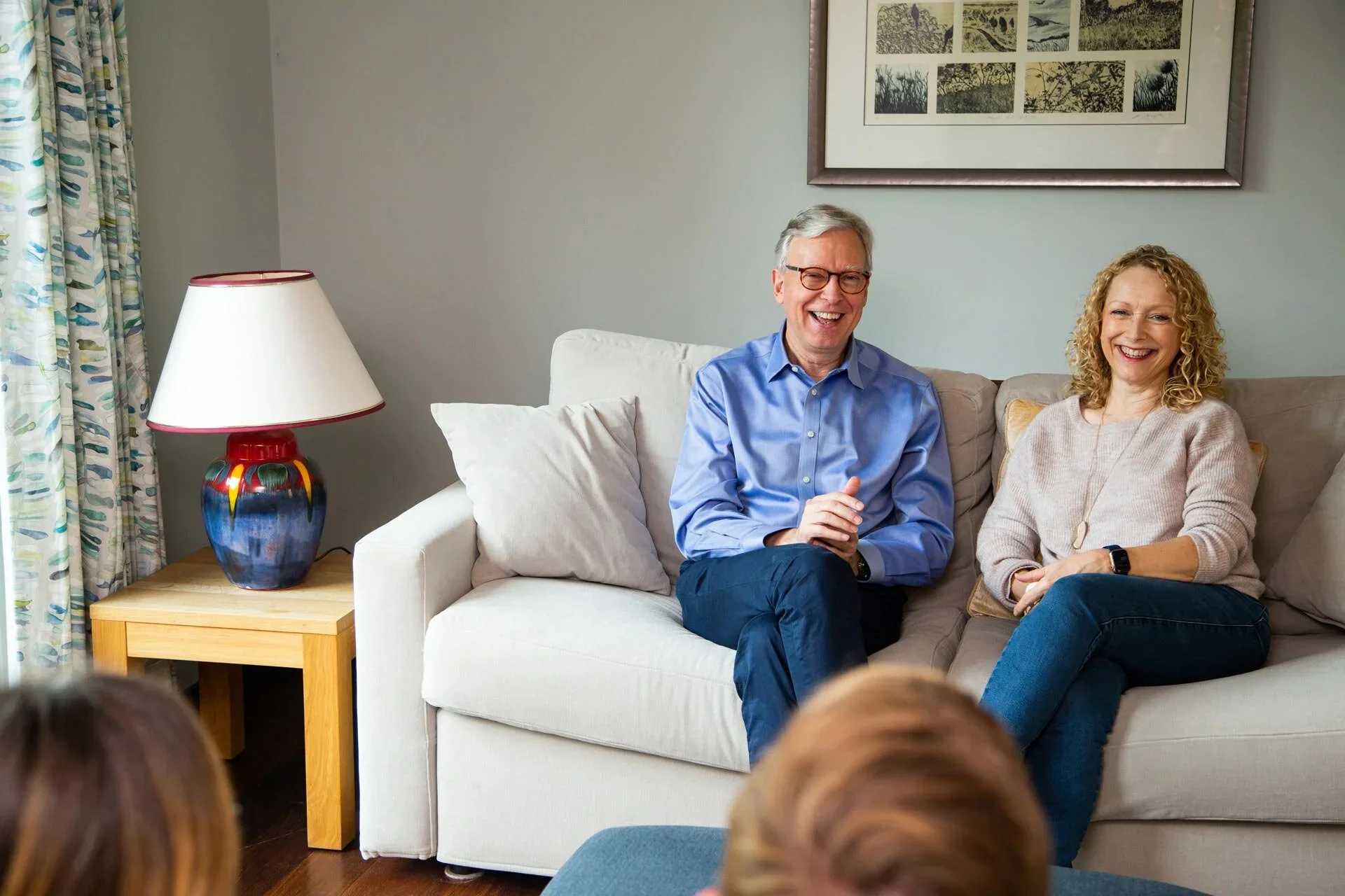 Keith and Juliet sitting on a couch, smiling