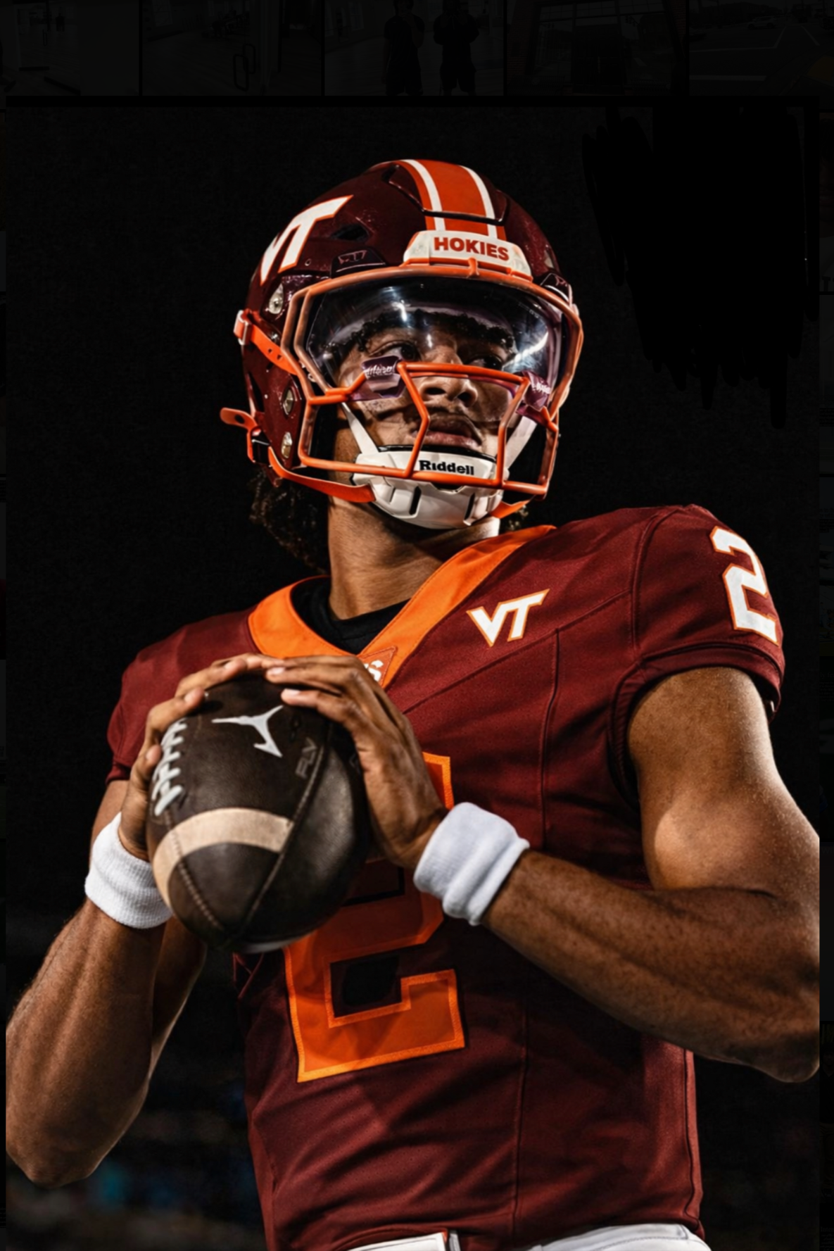 A football player in a Virginia Tech Hokies uniform holding a football, wearing a helmet with a face guard and a dark visor, against a dark background.
