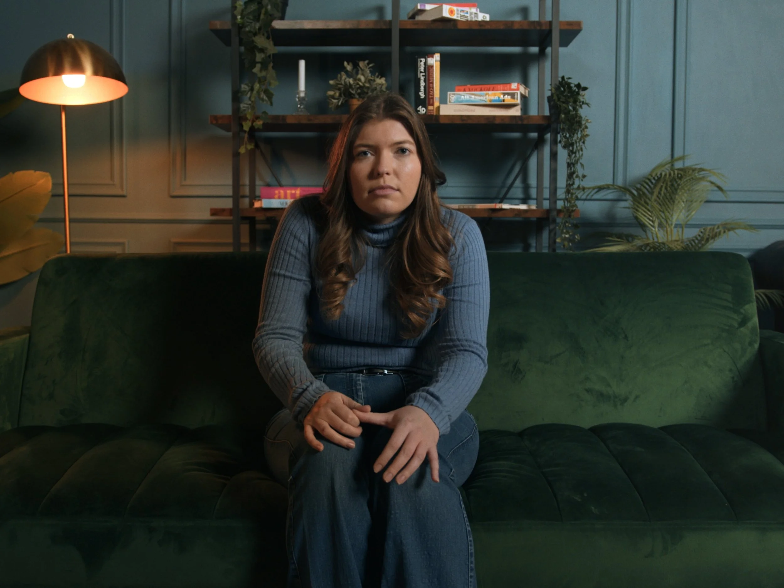 Woman sitting on sofa in therapy scene from "Ticking"