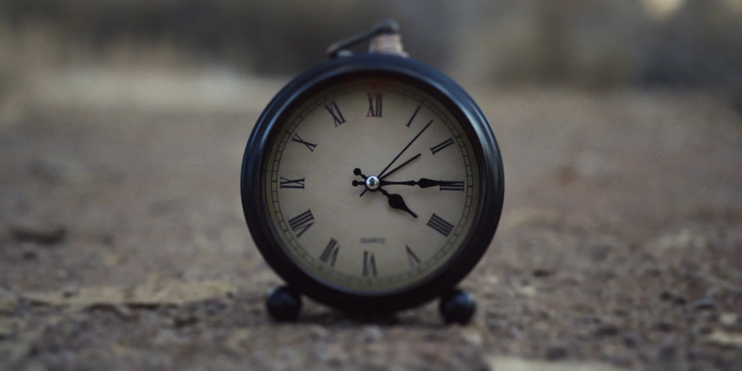 Closeup of clock on the ground in scene from "Ticking"