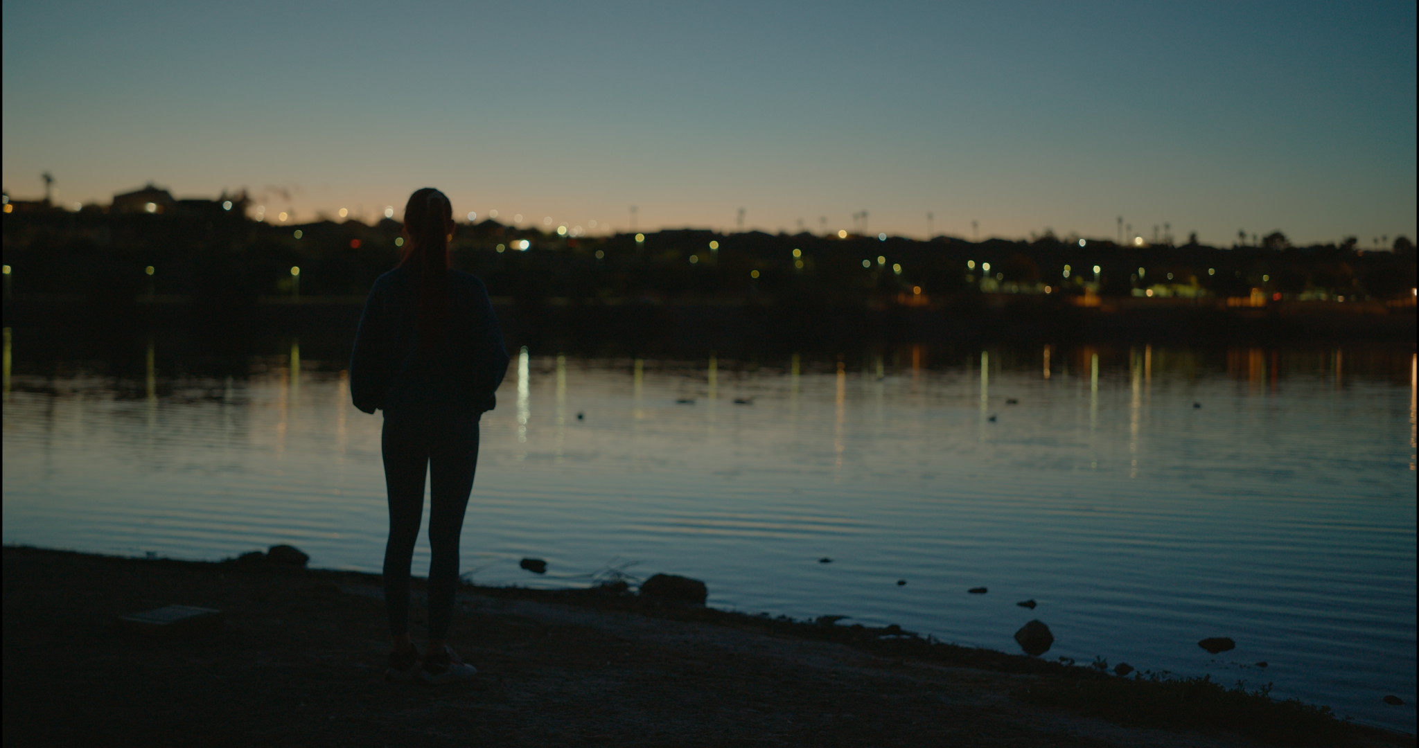 Silhouette of woman by the water in Nike Spec Ad