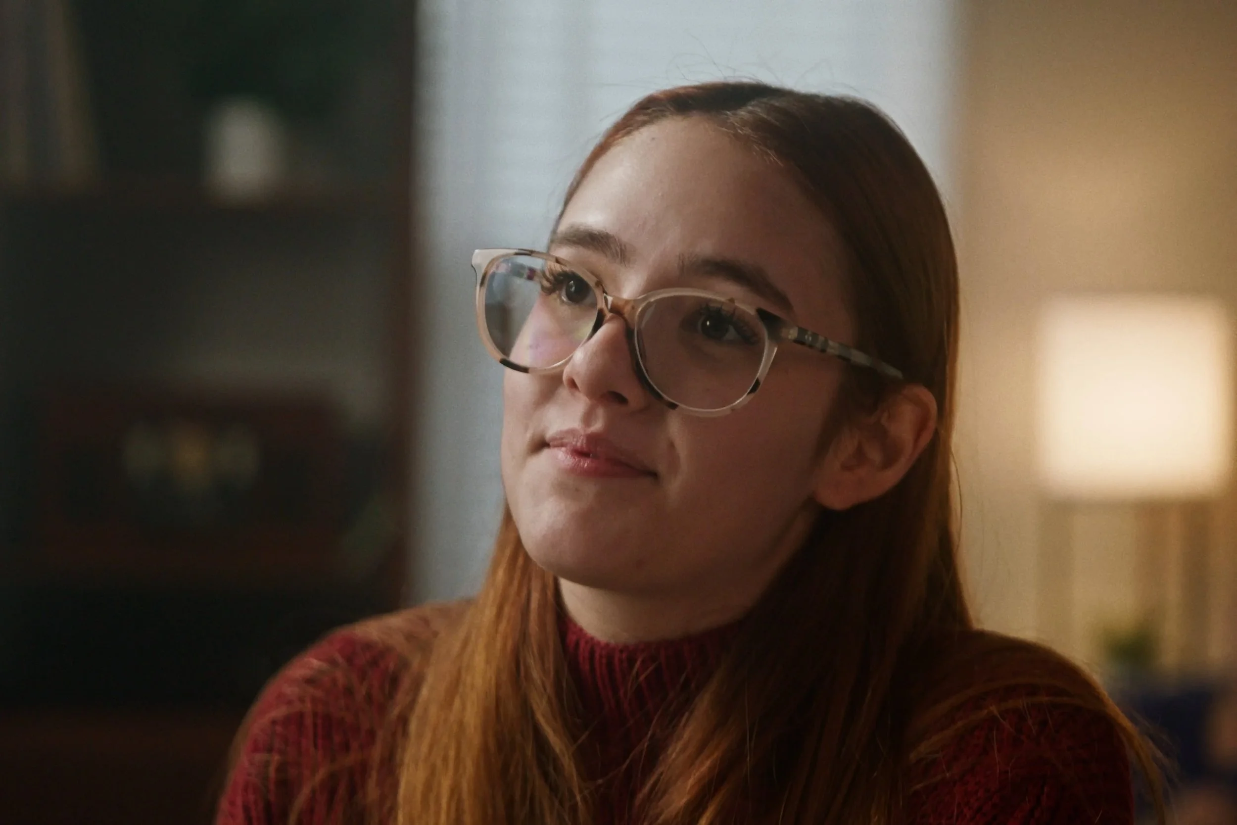 woman in glasses listening in scene from Something Good