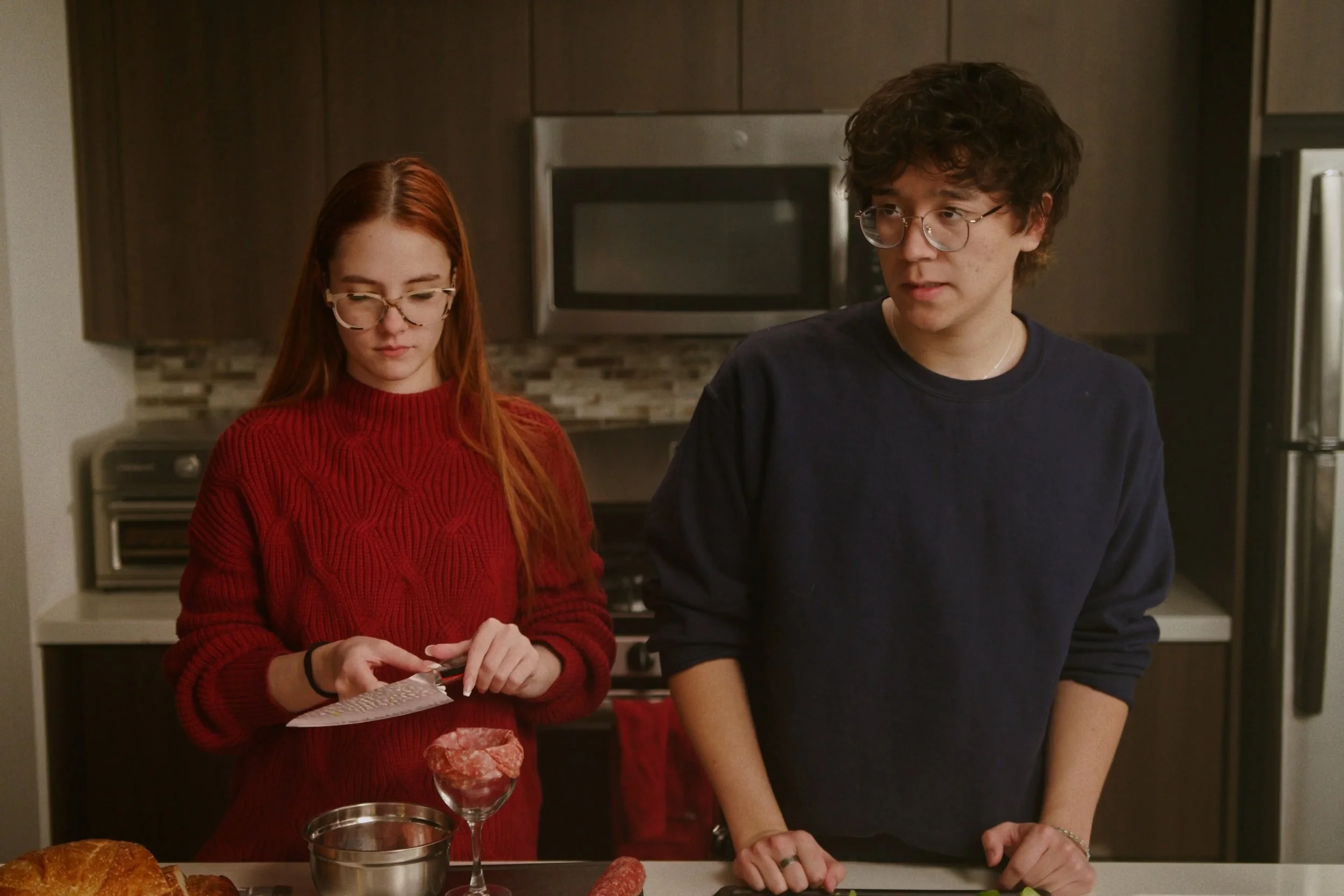Two friends cooking in scene from Something Good