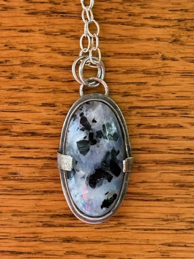Rainbow Moonstone On textured silver.